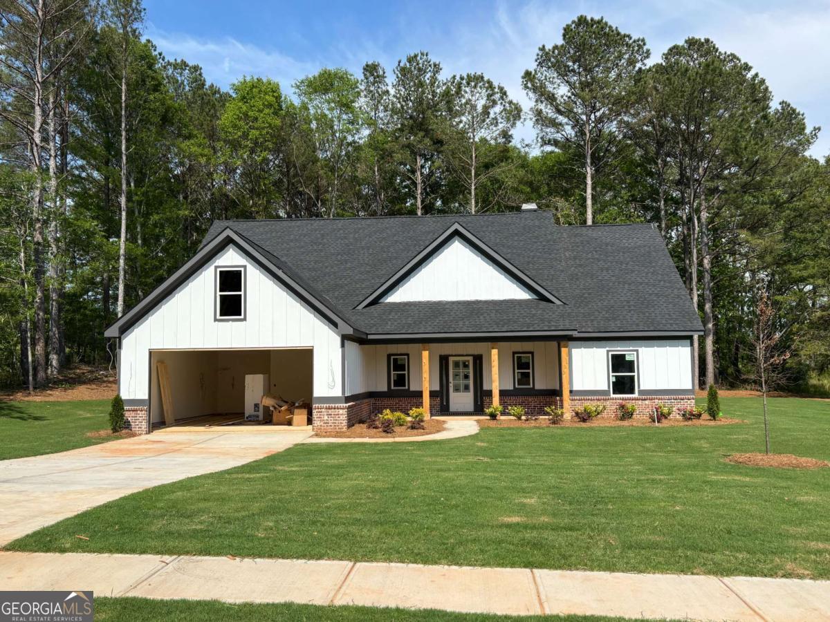 Final Opportunity in The Oaks at Alcovy! One-level home, 3 BR, 2 1/2 BA on .64-ACRE homesite. The entry foyer welcomes you to this bright Open-Concept design including a large Vaulted Family Room w/ beamed ceiling, well-appointed Kitchen boasting stone countertops, a breakfast island, and high-quality Stainless Steel Whirlpool appliances. The dining area opens to a Covered Back Patio. The Primary suite is privately tucked away down the hall featuring a tray ceiling w/ Crown Molding, Soaking Tub, Tiled Shower w/ frameless glass enclosure, Double Vanities, and large Walk-in Closet. Step right in from your garage and easily shake off the day in the mud room complete with a built-in bench & cubbies and walk-in pantry! ** UNMATCHED FEATURES include Tiled shower walls in BOTH full bathrooms, Frameless Glass Enclosure in Primary Shower, Granite or Quartz Countertops throughout kitchen AND bathrooms, Ceiling Fans in ALL bedrooms, living room & back patio, Tile Backsplash, Crown molding, Built-in Mudroom Lockers, Soft-Close doors and drawers on all cabinets, matte black hardware and lighting throughout, Garage Door Opener, 4-Sided Sod + Rain Bird sprinkler system on all 4-sides ** Single street community with just 41 total homesites. Only 3 miles from Publix @ the new Monroe Pavillion Shopping Center and just 10 minutes from downtown Monroe! Call, text, or email Derece for details! Projected close date SEP/OCT. Discover the perfect blend of luxury, functionality, and peaceful living in this exceptional property!