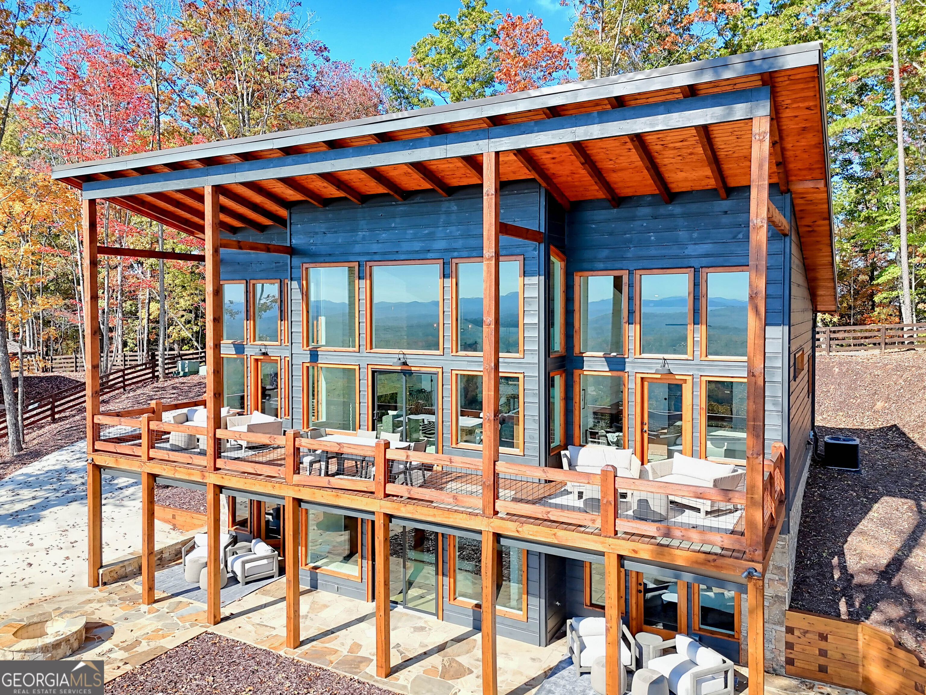 Perched in the peaceful North Georgia mountains, 530 Tower Road in Mineral Bluff offers the perfect blend of modern elegance. This stunning, designer furnished 4-bedroom, 4.5-bath home boasts an open, airy layout with vaulted ceilings and expansive windows that fill the home with light while framing the incredible long range views. The kitchen is a chef's dream, complete with high-end appliances and custom finishes, ideal for both everyday cooking and entertaining. The spacious great room, centered around a cozy fireplace, provides the perfect spot for gathering with friends and family. Step outside to the sprawling deck, where the fresh mountain air and gorgeous views create a peaceful retreat for relaxation or outdoor entertaining. Two primary suites on the main level offer spa-like amenities and access to the outdoors, while the additional 2 bedrooms each have their own en-suite baths, providing privacy and comfort for family and guests. With proximity to world-class hiking, trout fishing, and the charming town of Blue Ridge, 530 Tower Rd is a mountain retreat where luxury meets nature, perfect for both relaxation and adventure.