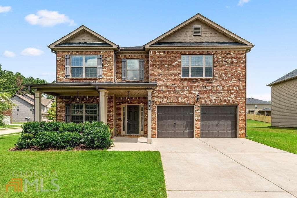 Fall in love and call this gorgeous brick-front 4-bedroom 2.5 bathroom home. Situated on a large corner lot, this home has been meticulously maintained and is ready for you to move in. Upon entry, you are welcomed by gleaming hardwood floors that lead to an open concept multifunction room and the formal dining area with coffered ceilings. The kitchen is a chef's dream with lots of counter space to avoid overcrowding of your favorite appliances. You can enjoy the warmth of the fireplace as you are watching TV and entertaining in the family room. Also, the main level includes a spacious powder room and a mudroom entry next to the 2-car garage. On the upper level, you will find the 4 bedrooms including the lovely owner's retreat with an ensuite bathroom that has a separate tiled shower and soaking tub. The hallway bathroom offers a double vanity and the laundry room has adequate storage space for your needs. Whether you are in need of an outdoor oasis or a place for your fur babies to run and play, the luscious backyard is ready for your personal touch. This home is 5 mins away from Publix, Starbucks, and near Downtown McDonough putting shops, restaurants, and entertainment right at your fingertips.