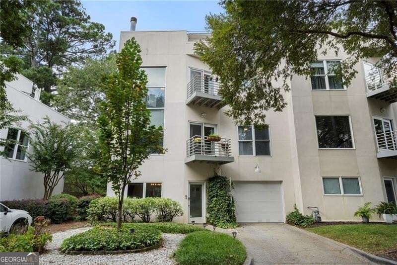 Welcome to this stunning 3-story contemporary townhome located in the heart of Brookhaven! Thoughtfully designed and beautifully updated, this home offers the perfect combination of modern style, functional space, and unbeatable location. The bright, open floor plan of this end-unit features a fireside dining area on the main level overlooking the fully renovated kitchen with quartz countertops and stainless-steel appliances. A convenient half bath and laundry room along with access to the one-car garage complete the main level. The second floor features a spacious living room and a comfortable guest bedroom, both filled with natural light, as well as a beautifully renovated full bathroom. The third floor is dedicated to the oversized primary suite, complete with a renovated en-suite bathroom. Enjoy the rare luxury of six private outdoor spaces, including a rooftop sky deck with incredible views, multiple balconies off the main living areas and bedrooms, and a private, fenced backyard. Natural light fills each floor, enhancing the clean, contemporary lines and comfortable layout. Situated just minutes from Brookhaven Village, this townhome places you in the heart of it all while still offering privacy and tranquility. Quick access to Buckhead, Midtown, and major highways.