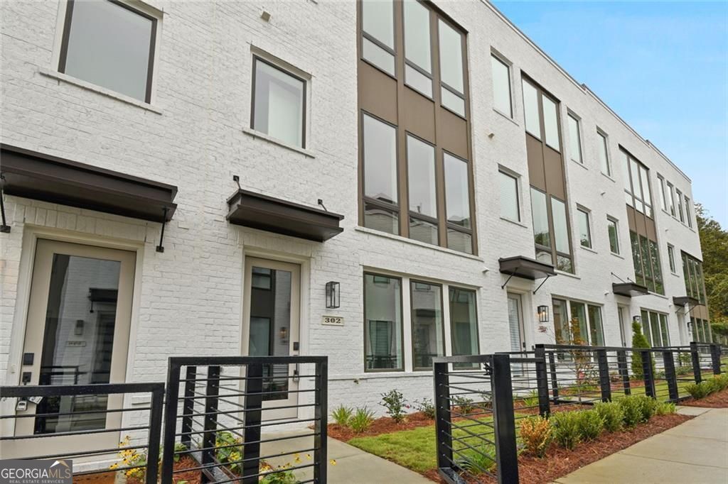 Discover the perfect blend of modern luxury and unbeatable location in this stunning 3-bedroom, 3.5-bath townhome in the highly sought-after Madison Yards community. Just moments from the BeltLine, vibrant shopping, dining, and major highways, this home offers the best of city living right at your doorstep. Step inside to a bright, open floor plan where soaring ceilings, floor-to-ceiling windows, and abundant natural light create a warm, inviting atmosphere. The gourmet chef's kitchen is a showstopper, quartz countertops, a spacious walk-in pantry with custom built-ins, and soft-close cabinetry, perfect for everyday living and entertaining. Retreat to your oversized owner's suite, complete with a spa-like bathroom and an expansive, oversized shower. Each secondary bedroom boasts its own private bath, ideal for guests or as a home office. A dedicated bonus room offers even more flexibility for your lifestyle needs. Plus a gated fenced front yard! Enjoy the convenience of Madison Yards living right in the heart of Reynoldstown.