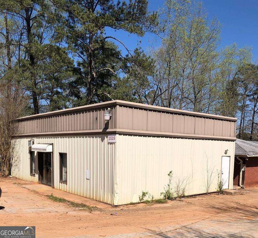 Excellent location - USED CAR DEALERSHIP and BODY SHOP for sale/lease. Lease 4900/month alternative. Excellent Investment Opportunity. 3 Buildings ON PROPERTY- Used car dealership, Body Shop and Office along with garage spaces for oil change/engine repair/paint shop - 6500 Sq ft+-. Near Walmart, Lowe's Home Improvement, Publix, right on exit I20, Traffic count +40,000 autos/day. FRONT BUILDING IS YEAR BUILT 1994.