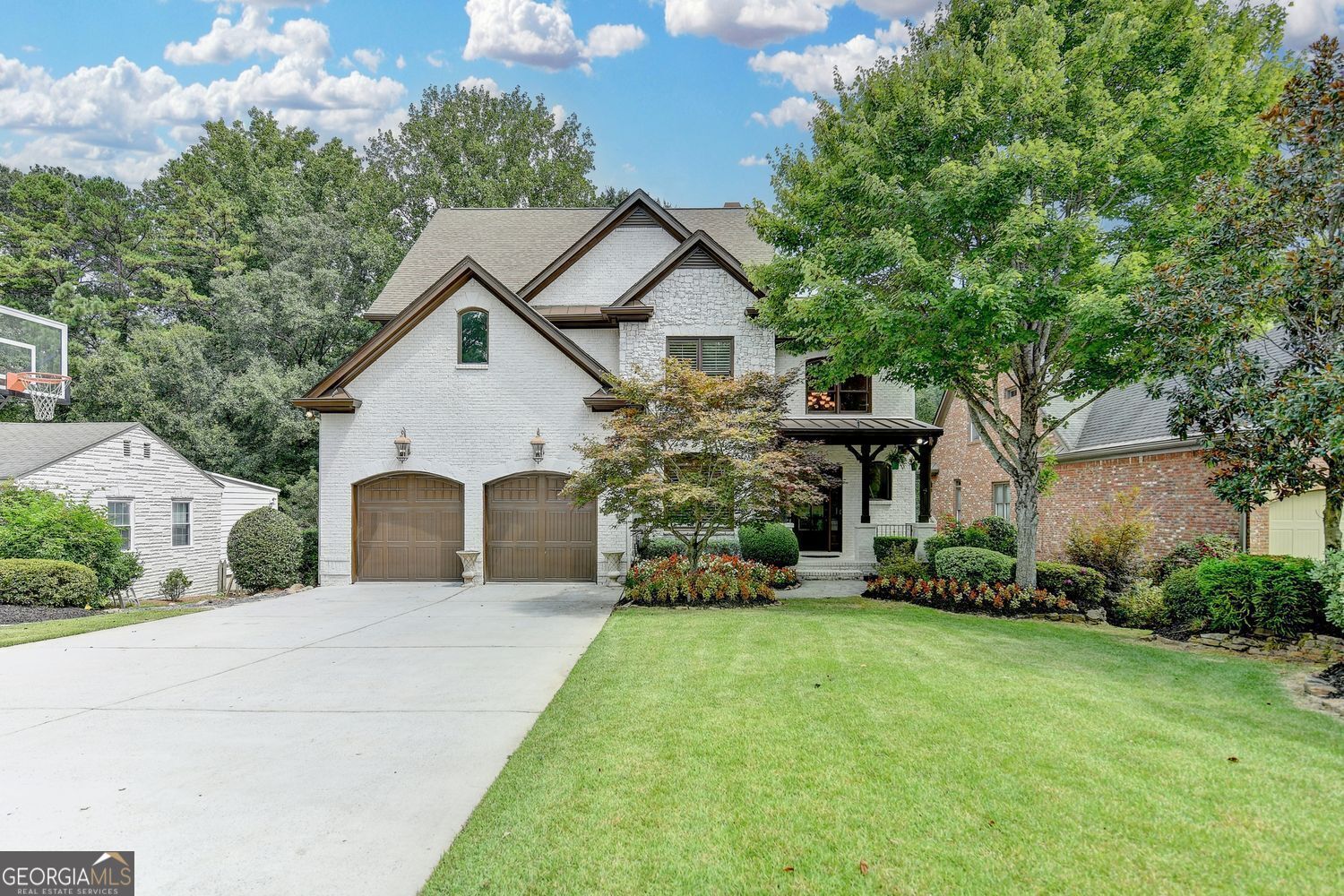 If you have been waiting for that special home, in a prime location in Ashford Park, welcome home! This amazing home is ready for you to just unpack your bags. As you enter the 2-story foyer, you will immediately notice the attention to detail. Open dining room perfect for large gatherings, a bedroom on the main perfect for relatives, and a large fireside keeping room overlooking the kitchen. Updated kitchen with center island and expansive counters, with ample seating and top-of-the-line appliances, make you want to cook. Separate kitchen dining and large enclosed deck overlook one of the area's best backyards. If you want a large, fenced backyard, perfect for pets and families, you need to see this lot. Upstairs there are 4 additional bedrooms and 3 full baths. The master suite has a fireplace and a wall of windows, with a large master bath with his and her vanities and large walk-in closet. Large secondary bathrooms as well. The unfinished basement is ready for your vision. Hardwoods throughout and two brand-new HVAC systems with AprilAire Filtration and blown-in insulation ensure low utilities. This home also features upgraded insulation and a convenient EV charger. This exceptional home is the best in luxury living in the middle of sought-after Ashford Park, where you can walk, bike, or take your golf cart to your favorite area restaurants. This home is truly a one-of-a-kind property.