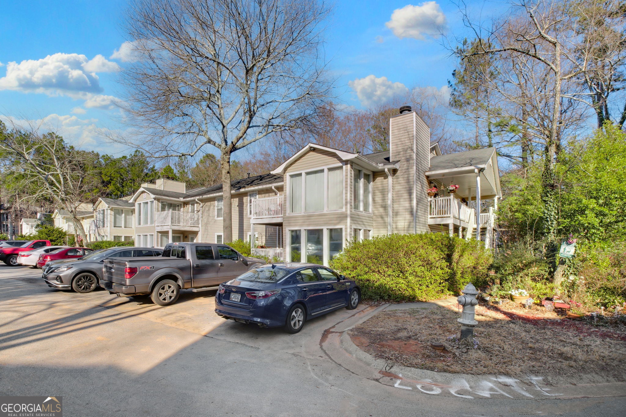 Welcome to your own private entrance Condo! Lots of windows with a wooded view. This home has lots of new upgrades. All stainless steel appliances. New dishwasher, stove, refrigerator, washer and dryer, garbage disposal included. Granite countertops. All hardwood flooring throughout. Bathroom has been completely remodeled. New vanity, tub, toilet and tile to the ceiling. All new fans and fixutres. Entire home is freshly painted. Fireplace has gas starter and there is a lovely sunroom overlooking the covered porch. This home is ready to move in and enjoy! Close to I-75, KSU and Life University. The HOA is very well run with low fees. Very responsive to the homeowner's needs. It includes your water and sewer as well. This home also makes a great investment property as there is no rental restrictions. Great neighbors and amenities. Come by and take a look at your new home!