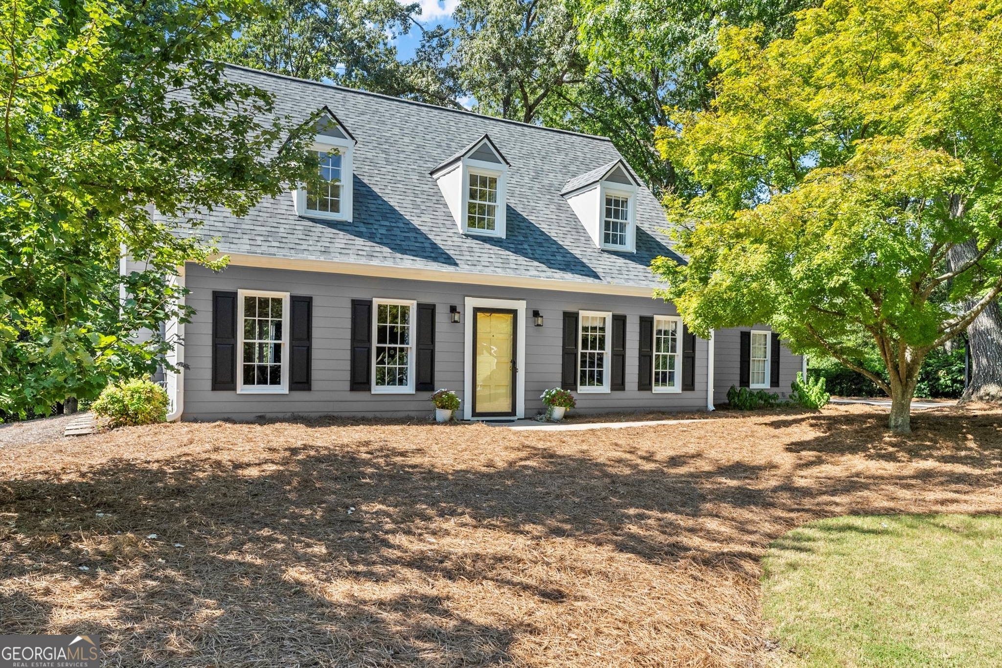 Don't miss your chance to make this darling Cape Cod charmer situated on a flat lot on a cul-de-sac street HOME! Upon entry, you'll be greeted by beautiful hardwood floors, natural light pouring into windows and a great-flowing floorplan. Formal living room open to spacious living room can be used as sitting room/office/playroom, and living room with wall of windows is centered by beautiful fireplace and mantle. Kitchen features newer white cabinet faces up to the ceiling, with glass-front uppers, stainless steel appliances, a gorgeous marble backsplash and granite counters, with a generous breakfast nook facing the backyard. Laundry room off the kitchen offers extra storage as well as a separate pantry space. Dining room at front of home offers a beautiful space to gather. Upstairs, the primary suite is a beautiful retreat with gorgeously renovated en-suite with double vanity, designer tile and beautiful frameless glass shower. Bonus room over the garage offers a spacious secondary living area to use as you'd like, and two secondary bedrooms and shared bathroom. Start your day with coffee in the screened in porch and end your evening winding down around your firepit area taking in your flat yard. There's so much to love in this home, and all in a gem of a neighborhood with swimming pool, playground, and tennis courts/all sports court, in the heart of East Cobb with top schools, and just a 10 minute drive to downtown Roswell, The Avenues, and tons of other shopping and dining options!