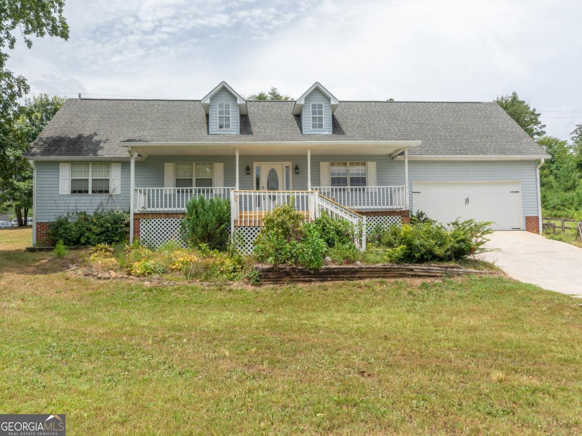 This charming one-level home offers 3 bedrooms and 2 full bathrooms, perfectly situated on a peaceful corner lot just over an acre in size. The setting is serene and private, with stunning views that can be enjoyed right from the front and back porches. Whether you're watching the sunrise with a cup of coffee or relaxing in the evening, the natural beauty surrounding the property provides a true sense of retreat. Inside, the layout is open and functional, designed for easy living and comfortable flow throughout the home. The attached two-car garage offers plenty of space for vehicles and storage. Outside, the fenced backyard is ideal for pets, gardening, or simply enjoying the outdoors. A small shed adds extra utility for tools or seasonal items. This home combines peaceful country living with modern convenience, making it a perfect place to settle in and make your own.