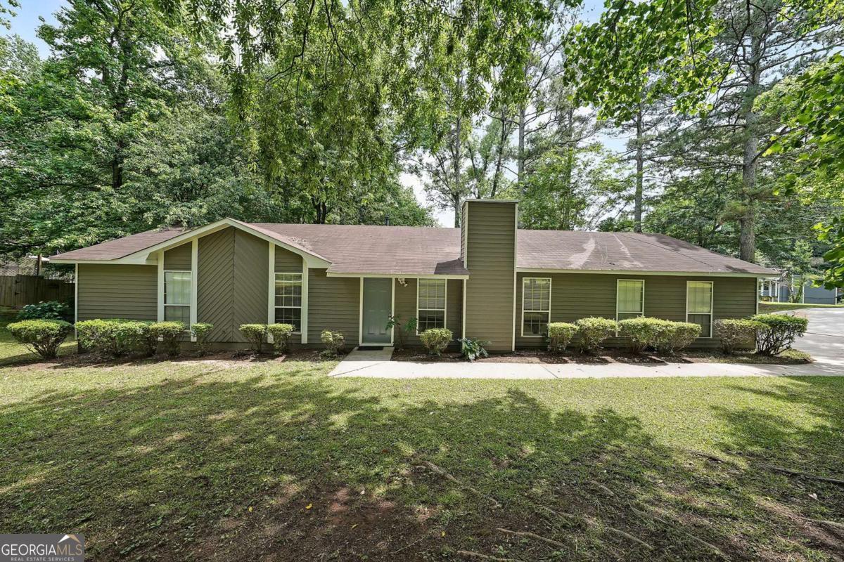 Welcome to this beautifully renovated ranch on a corner lot, offering timeless curb appeal with a side-facing two-car garage and separate garage doors for added privacy and function. With a freshly painted interior and exterior, this move-in-ready home seamlessly blends modern updates with classic charm in a well-established, quiet neighborhood. Thoughtfully updated by the seller, every detail has been carefully considered from the refreshed cabinetry and new appliances in the kitchen to the updated bathrooms, new lighting, and fresh finishes throughout. The spacious layout includes a vaulted family room that creates an inviting atmosphere perfect for entertaining or relaxing. The generously sized bedrooms offer comfort and flexibility, while the updated layout maximizes function and flow. Step outside to the newly built deck, ideal for enjoying your morning coffee, grilling with friends, or dining under the stars. Surrounded by shade trees and peaceful wooded views, the outdoor space is full of potential, ready for you to personalize and enjoy with no HOA restrictions. Whether you're a first-time buyer or an investor looking for a quality addition to your portfolio, this home is a standout. It's being sold as-is, but the quality renovations speak for themselves, clean and stylish from top to bottom. Don't miss this incredible opportunity to own a thoughtfully updated home with charm, privacy, and room to grow!
