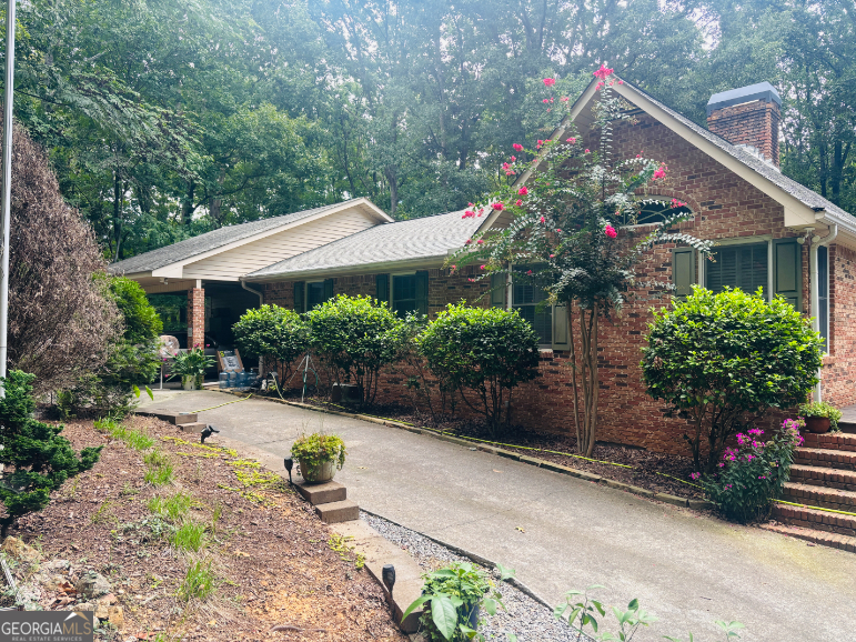 An outdoor lover's paradise! Nestled on over 12 private wooded acres with a creek, this property offers endless opportunities for hunting, riding ATVs, gardening, and enjoying nature. Already set up with deer stands, shooting targets, garden, chicken coop, invisible fencing (with 2 collars), storage shed/workshop, and a self-watering greenhouse. Owner has invested heavily in upgrades including a concrete retaining wall, extensive landscaping, a beautiful stone-paved patio and walkway, and a wraparound deck to take in the views. Step inside this beautifully updated living space. The remodeled kitchen features white-stained cabinets, granite countertops, farmhouse sink, stainless steel appliances, and a double oven-open to the breakfast room and family room with soaring ceilings, a wood-burning fireplace, and Andersen lifetime windows and doors for abundant natural light and energy efficiency. The spacious master suite on the main level boasts vaulted ceilings, four closets including a massive walk-in, and a master bath with extended dual vanities and tile floors. The oversized den offers a built-in bookshelf, dining space, wine fridge, beverage cooler, surround sound, and a home theater with pull-down projector screen over a cozy gas log fireplace. Flooring has been upgraded throughout the main level to 3/4" hickory hardwoods. The fully finished basement adds three generously sized bedrooms with LVP flooring, including one with a reinforced safe room (rebar walls and built-in safe) ideal for gun storage or storm protection, and another with its own wood-burning stove. With its combination of luxury finishes, functional upgrades, and unmatched outdoor amenities, this rare property is the ultimate private retreat with space for recreation, entertaining, and everyday living.