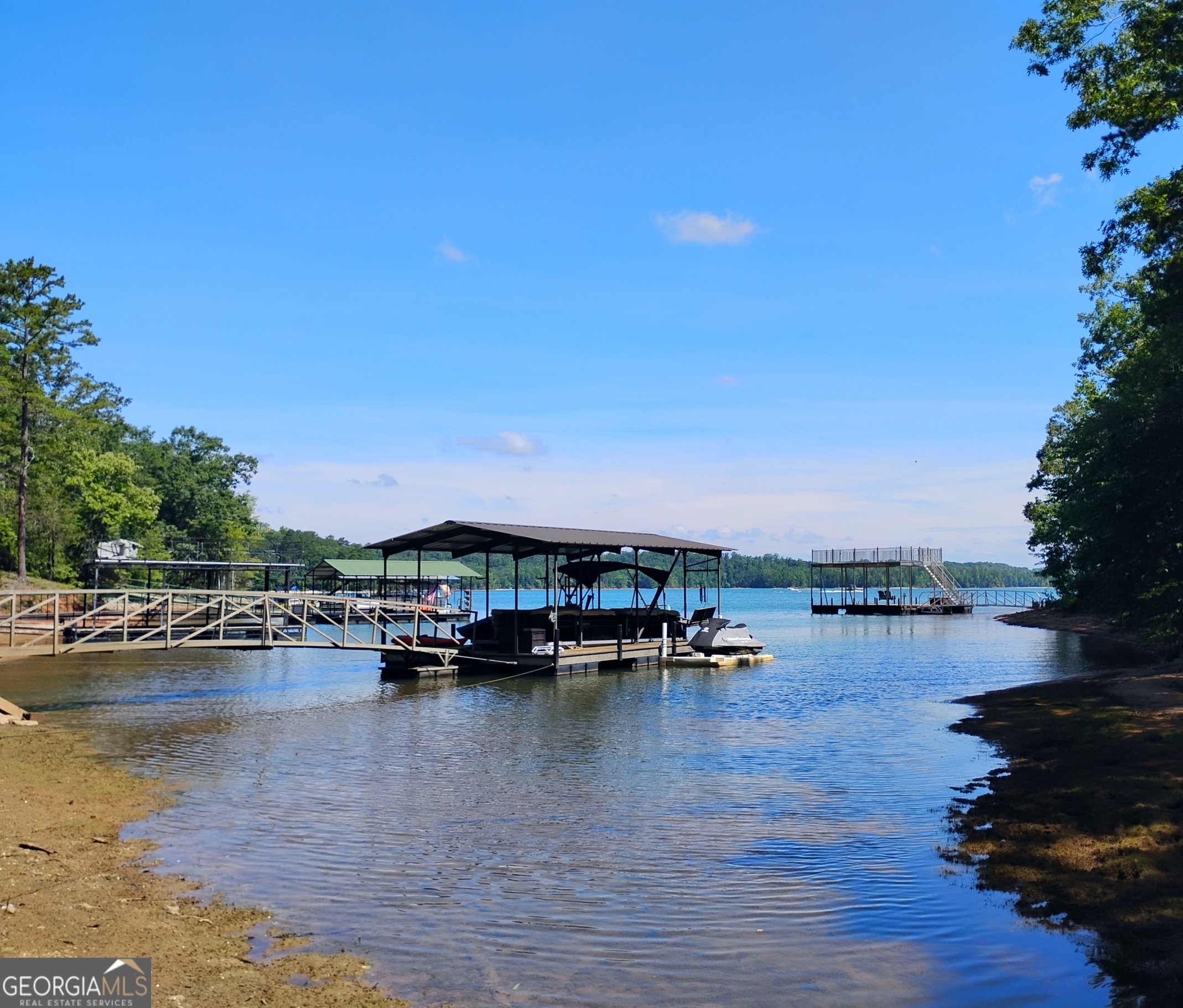 Beautiful 2+ acre private tract with 96 feet of lake frontage. Driveway already cut in with several nice build sites. Views of lake and great mature hardwoods. Short boat ride multiple marinas and restaurants. Property is green zone but not dockable. The corp allows you to beach your boat short term. Can also do corp approved underbrushing for even more views. Very nice area with several new construction homes being built. 2,000 sq ft minimum. No mobiles allowed. Drive is shared with the 3+ acre property to the right and runs down the right property line of Tract A. Restrictions, soil map and survey on file.