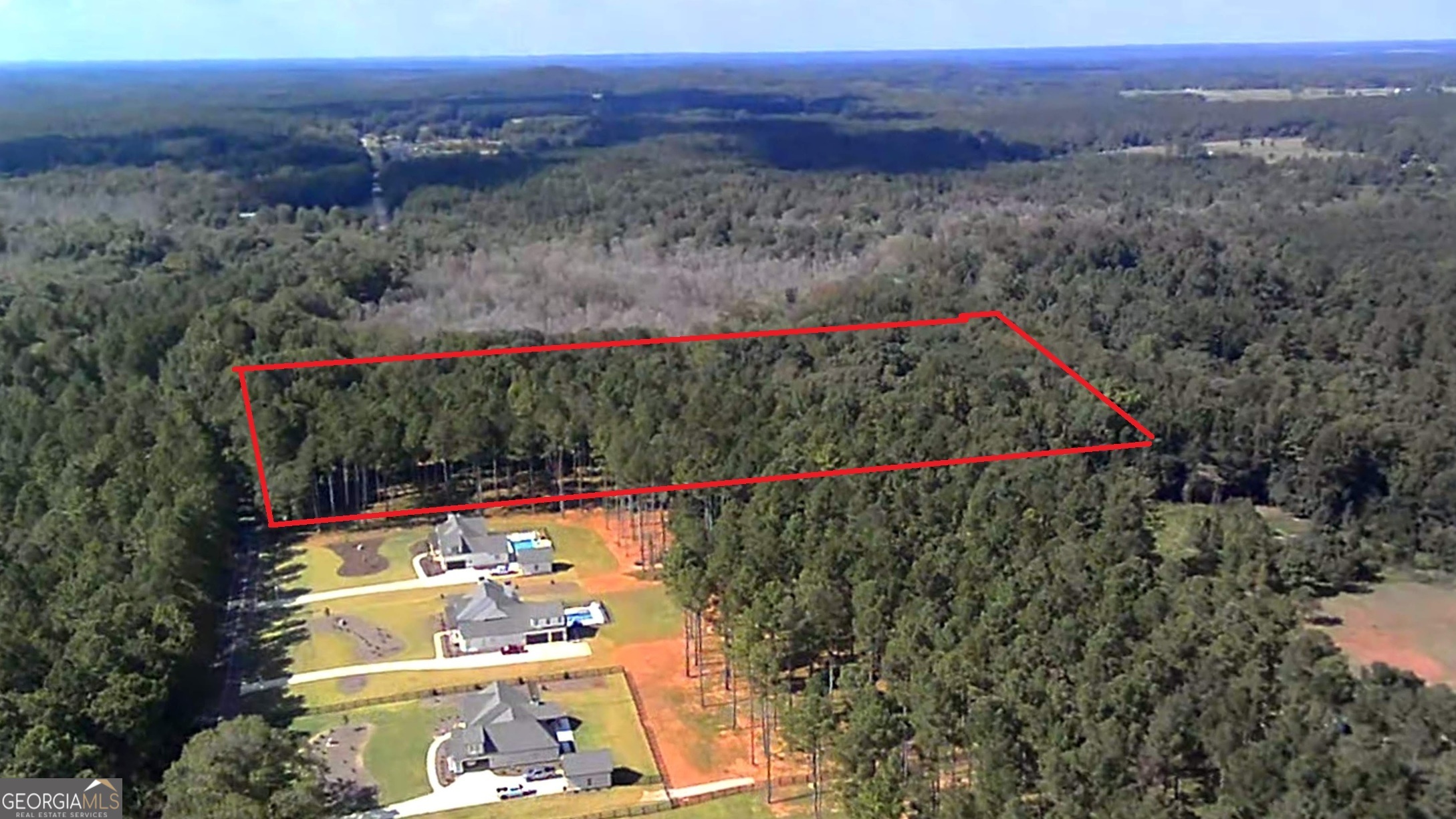 Just under 5-acre lot suitable for a mini-farm located in Walton County, right outside the City Limits of Good Hope. This is one of the last two remaining buildable lots in a line of newly built luxury modern farmhouses. These homes all recently sold for up to $800,000. This is lot 15 of Hester Estates, with no HOA fees. To the left (NW) is a 45-acre lot with most of its land (nearly 40 acres) in a flood zone. To the rear (NE) is land owned by Thompson's Tree Farm and to the right (SE) is a new luxury farmhouse. It's only 11 minutes to Monroe and 24 minutes to Athen's shopping. The front half of the tract is raised up from the road and level to about half way back. This front portion is a field of timber pine ready for harvest if desired. This area would be a perfect field for horses or other farm animals. There is plenty of room for a barn, chicken pens, tractor sheds and more. At about halfway back, there is a slight slope down, suitable for a basement home. There are also plenty of building locations for a slab foundation as well. The back half of the property transitions to old growth hardwoods full of oak trees, poplars and even a few pecan trees. The rear forest canopy is so shady that the land is free of underbrush. Plus, there is a full-time flowing creek along the rear property line. This perennial stream draws deer, turkeys, and a variety of other wildlife. There's not a neighboring home visible from the rear of the land. The land has already had a "perc test" (percolation survey) and is suitable for a septic system. The full survey, soil test and flood map are available on request.