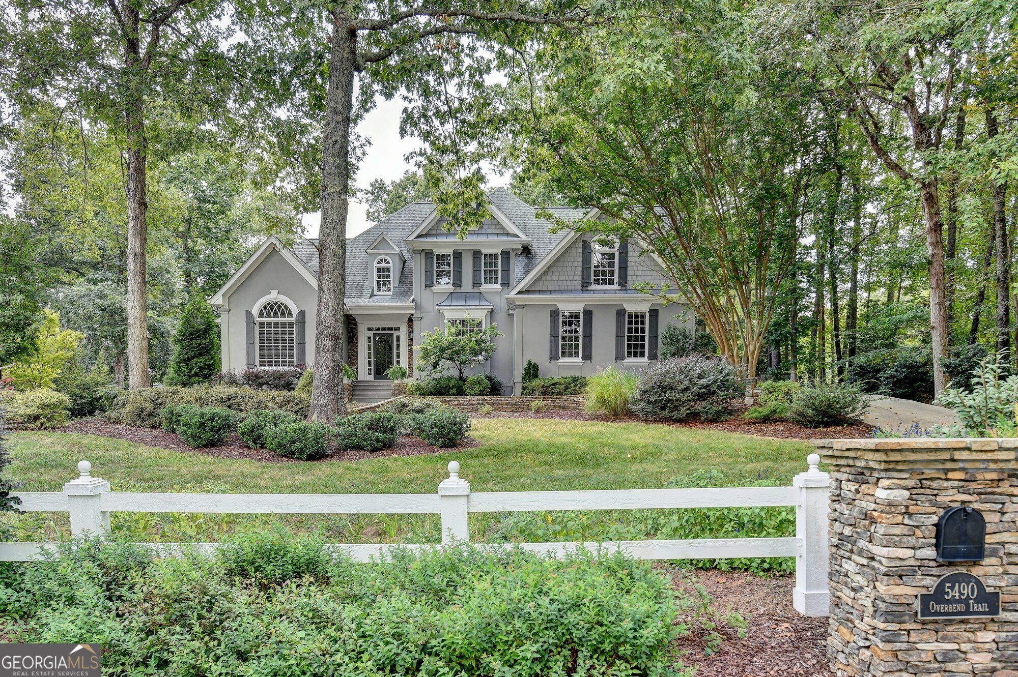 This stunning, meticulously maintained home has been customized for the most discerning buyers. The professionally landscaped front yard leads you to a grand entrance and into a soaring, light filled 2-story foyer. The view into the backyard overlooking the deck, through the beautiful and spacious great room is bright and airy - giving you the feeling that you are in a private oasis. The oversized primary is just off the great room with a tiled fireplace and sitting area.the perfect space to unwind after a long day. The large en-suite has been modernized with double vanities, a free-standing tub and tiled shower. The updated eat-in kitchen has been outfitted with stainless steel appliances, quartz countertops, a large island and numerous cabinets. Off the kitchen is a spacious laundry room, half bath and a larger than normal garage. Upstairs you will find 4 large, secondary bedrooms with lots of storage in addition to 2 more full baths. The 2100 sq ft basement is unfinished and waiting for your special touch. Located within the prestigious North Gwinnett school district, close to I-85 and Suwanee's many restaurants and shops. Don't miss the opportunity to see this fabulous home.
