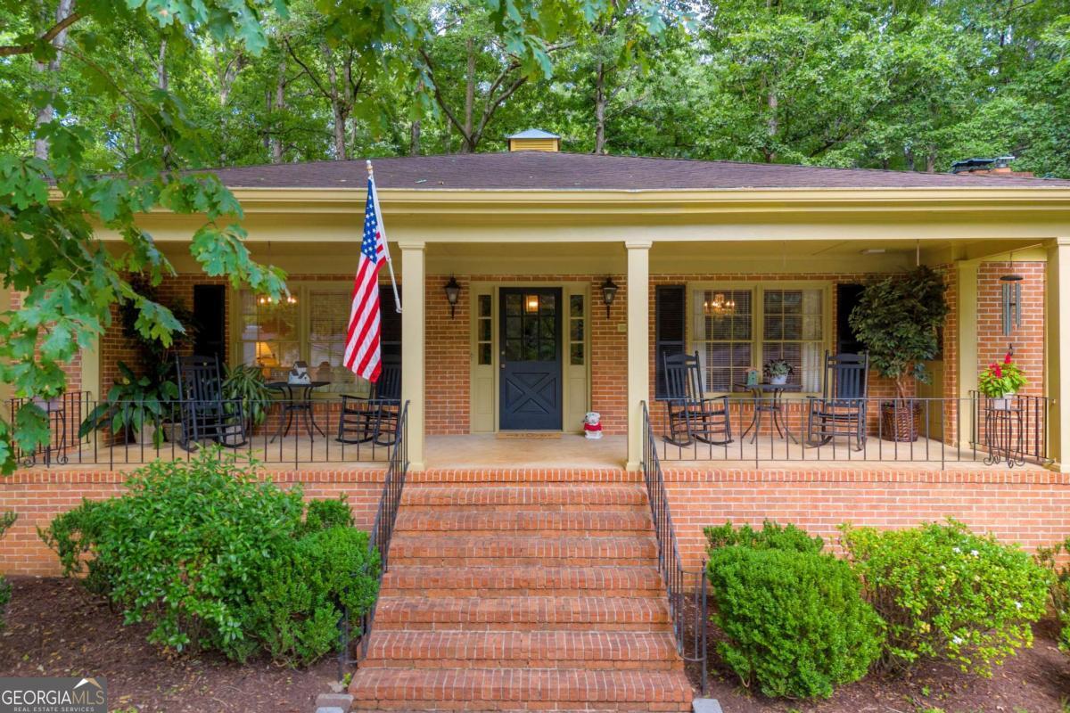 Classic Charm Meets Modern Comfort in the Heart of Athens! Welcome to this stunning all-brick ranch located in the highly desirable Homewood Hills neighborhood! This spacious, solidly built home offers all the convenience of single-level living with generously sized rooms and beautiful hardwood floors throughout. Situated on a large lot with a circular driveway, this home makes a statement from the moment you arrive. The expansive front porch is the perfect spot to relax and greet guests. Inside, you're welcomed by a gracious foyer flanked by a formal dining room on the right and a sunlit living room on the left-ideal for entertaining or a quiet retreat with your favorite book. The heart of the home is the spacious kitchen, featuring an abundance of counter space and cabinetry-perfect for anyone who enjoys cooking or hosting. Just off the kitchen is the expansive family room, anchored by a large masonry fireplace and offering so much room to gather, unwind, or host family and friends. Also adjacent to the kitchen is a versatile office/laundry room, which could easily serve as a craft or hobby space. Down the hall, you'll find three generous bedrooms, each with ample closet space and direct access to a bathroom-a rare and convenient feature. The home is filled with large windows that flood the rooms with natural light, creating a warm and welcoming atmosphere. The finished basement offers even more room to spread out, with another masonry fireplace, a game room, and a flexible open area that could serve as a media room, playroom, or secondary living space. Two additional bedrooms and a full bathroom on this level make it ideal for guests, teens, or extended family. Step outside and enjoy the huge fenced backyard, complete with a charming center gazebo-the perfect place to sip morning coffee or unwind with a glass of wine in the evening. All of this is nestled in a prime Athens location, with easy access to Loop 10, top medical facilities, shopping, and dining. Don't miss your opportunity to own this beautifully maintained home in one of Athens' most sought-after neighborhoods! Owner is a licensed Realtor in Georgia.