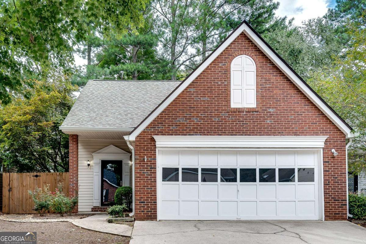 Welcome home to this immaculate property, where location meets lifestyle in one of Alpharetta's most desirable neighborhoods. Perfectly positioned just a 2 mile drive to Downtown Alpharetta, a short walk to Wills Park, and only minutes from the Avalon and Downtown Crabapple, this home puts dining, shopping, entertainment, and recreation right at your doorstep. Inside, you'll love the beautiful hardwoods on the main floor and the open-concept layout that creates a seamless flow between the fireside family room (contains 20 ft ceiling), dining area, and kitchen- perfect for both everyday living and entertaining. The updated kitchen is a chef's paradise, featuring granite counters, tiled backsplash, stainless steel appliances, a gas cooktop, and plenty of countertop space for your culinary needs. The primary suite on the main level offers comfort and convenience, featuring a fireplace, vaulted ceiling, a spacious walk-in closet, and an ensuite bathroom equipped with a jacuzzi tub, a glass-enclosed walk-in shower, and a large vanity. Upstairs, you'll find two additional spacious bedrooms and a full bath, providing plenty of space for family, guests, or a home office. Enjoy outdoor living space with a private fenced-in backyard, large patio, and low maintenance astroturf, creating the ideal space for relaxing, grilling, or hosting family and friends. Front yard landscaping, washer, and dryer included with unit. With its unbeatable walkable location, charming neighborhood setting, and easy access to GA-400, this property is a rare find in the heart of Alpharetta. Schedule your private tour today and experience the best of city convenience and suburban charm!