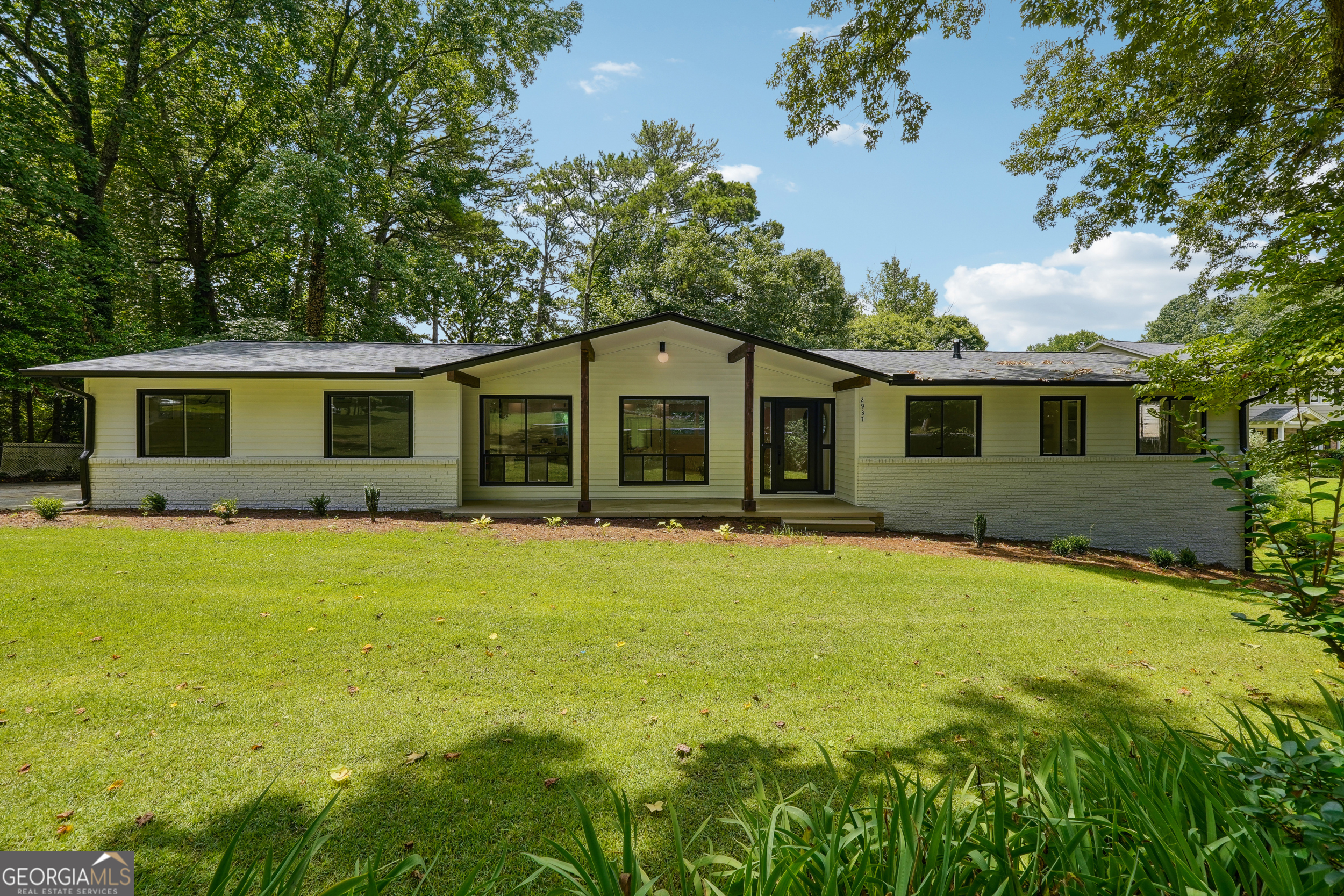 Welcome to this beautifully renovated ranch in Whispering Hills, Chamblee! Open the front door to gleaming luxury flooring, gorgeous fireplace, custom built-in shelving and tons of natural light throughout. Entertain friends and family in the formal dining area, as well as the open kitchen and living spaces. Whip up delicious meals in your chef-ready Kitchen with stainless-steel appliances including gas range, glass range hood, white shaker cabinets for days, sparkling quartz countertops, and massive Island w/ extra seating and storage. Relax in your private master on main with spacious closets equipped with custom built-in shelving plus a refreshing ensuite bathroom boasting double vanity and large floor to ceiling tiled shower. This home includes a full sized laundry room, 2 additional bedrooms upstairs, 2 bedrooms downstairs, bonus room with extra closet space, open entertainment area and room for a movie theater. Return from a long day of work to your spacious 2 car garage and driveway with plenty of room for extra parking. Enjoy outdoor living with evenings on your front patio and afternoons in your huge backyard with lower patio or long wood deck with gas hookup. This home is move-in ready with NEW Appliances, Lighting & Plumbing Fixtures, Paint, Roof (50 Year Architectural Shingles), Gutters, HVAC, Electrical and Updated Plumbing and more! Stay close to it all; I-85, Mercer University, CDC Chamblee campus, Dekalb Charter schools, less than 10mins from Briarmoor Manor Pool & Recreation, Parks, Restaurants, Shopping and more. Don't miss out on the opportunity to make this charming house your new home. Schedule a showing today and experience the best of Chamblee living!