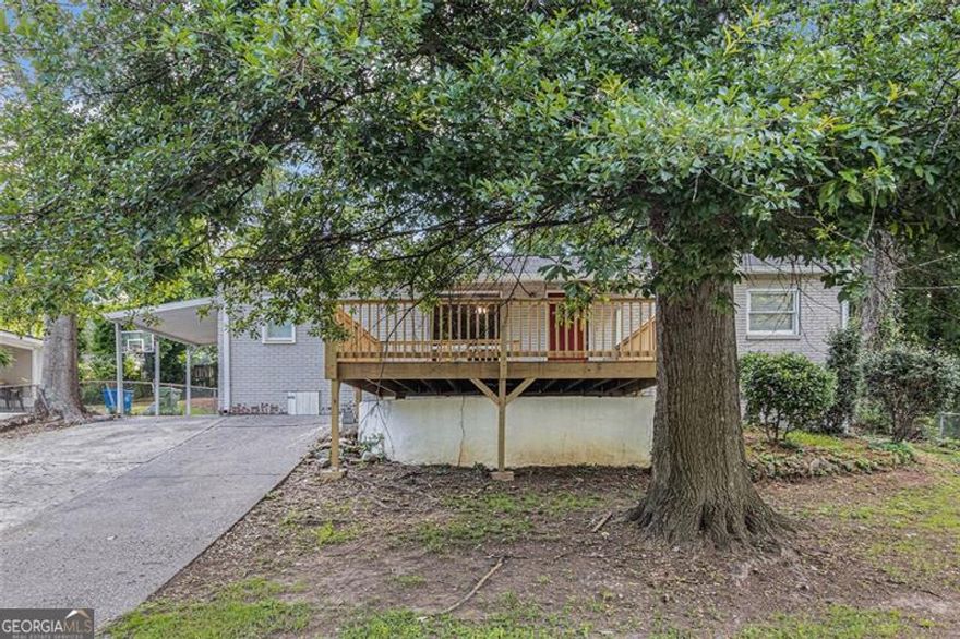 Charming ranch-style home featuring a 4/2 layout with a carport, a brand-new front deck, and a large backyard perfect for outdoor enjoyment. This well-sized property offers functional living space and outdoor upgrades that enhance curb appeal and comfort.