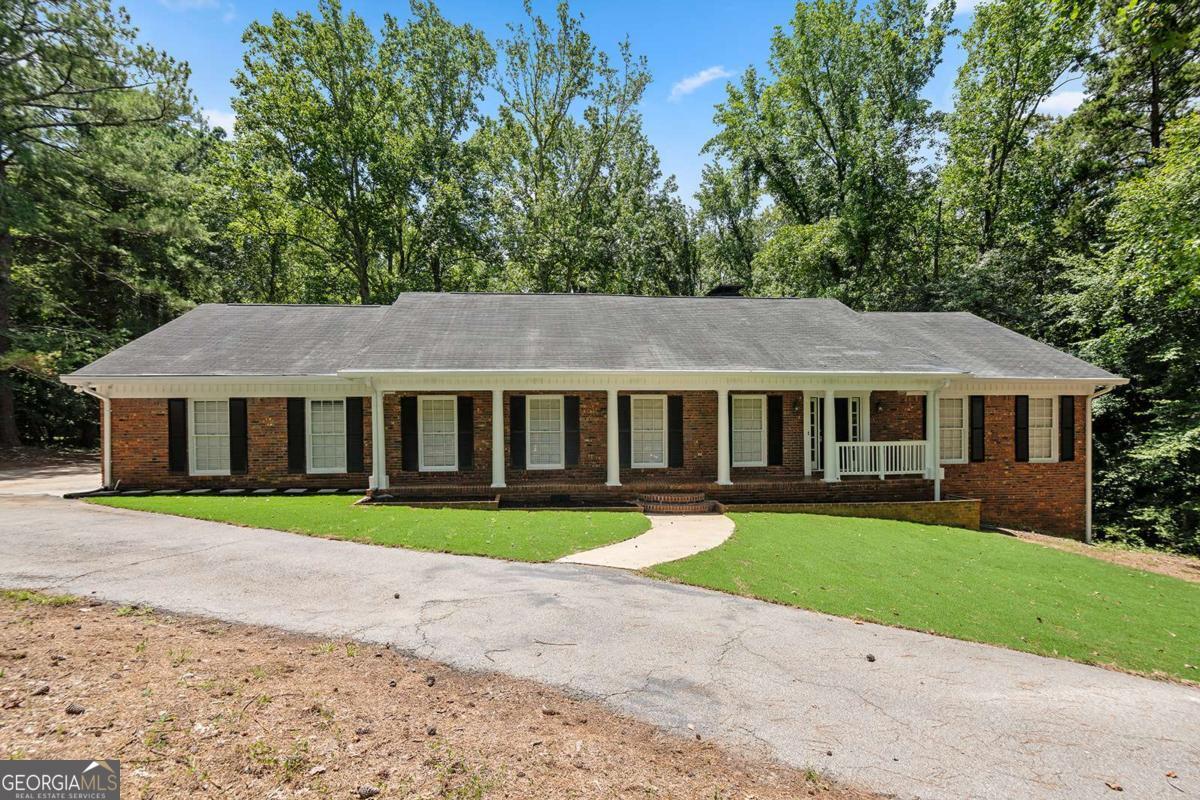 Tucked in an established Fairburn community, this four-sided brick gem offers timeless curb appeal. Perfect for a large family. Enjoy a side-entry 2-car garage, inviting front porch, private fenced backyard, and both an open deck and a screened-in back porch, perfect for relaxing year-round. Inside, discover elegant spaces including a formal living and dining room, breakfast nook, gas range, laundry room, and a finished basement with private exterior entry for added versatility. Owner has installed a NEW roof & NEW HVAC unit for upstairs. This home blends character, comfort, and convenience schedule your showing today!