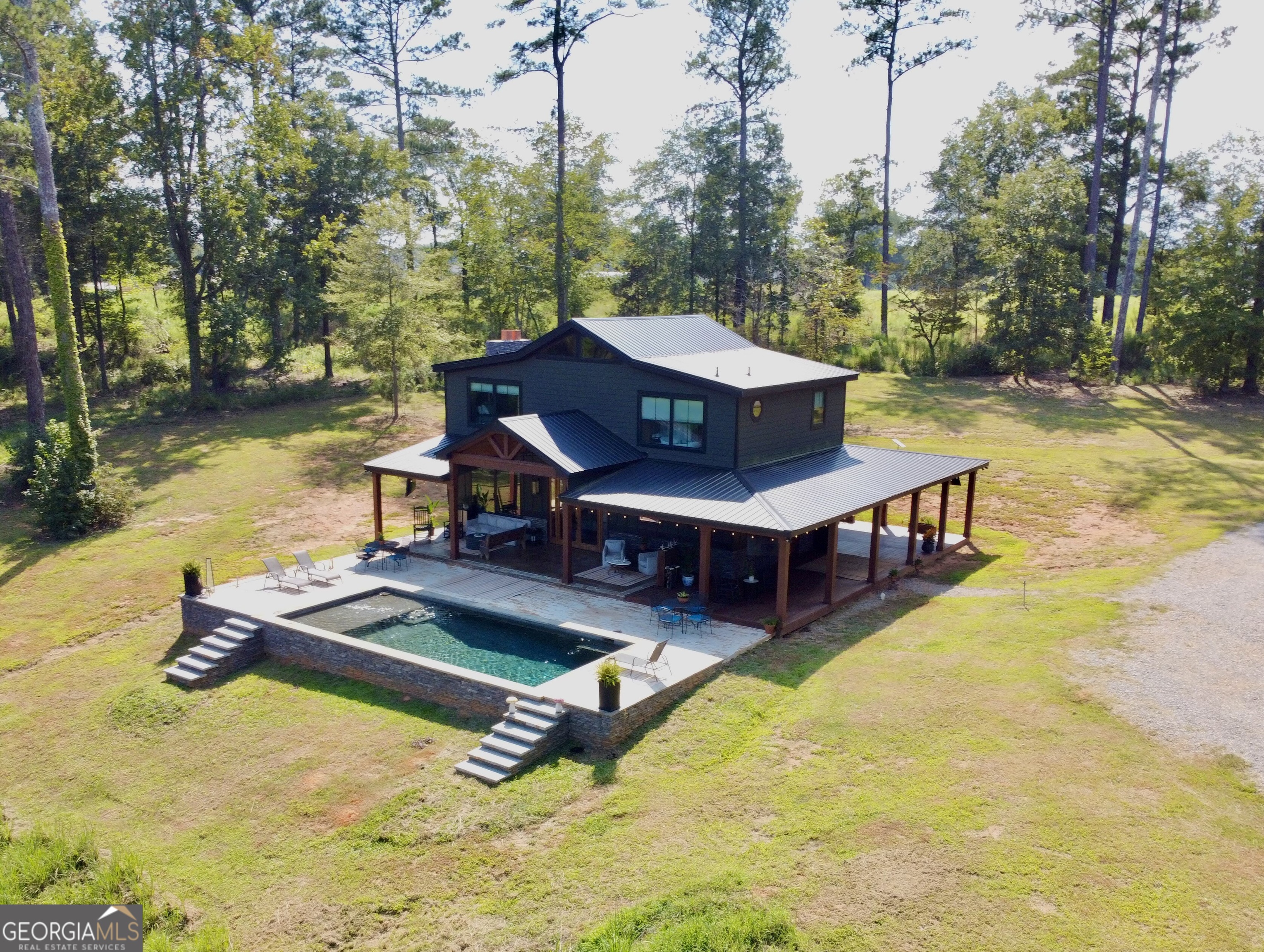 This hidden gem is tucked far off the road on 25 acres, offering complete privacy and tranquility. The property features a serene pond, open space for a large garden, animals, or your forever dream home. With enough road frontage for an additional two homes and a guest house, it's ideal for a family compound, investment property, or future development (with county approval). The custom-built cabin showcases beautiful craftsmanship by a local builder-featuring hardwood floors, built-in bookshelves, wood accents throughout, and a bar area perfect for entertaining Modern Comforts: Whole-house audio system with zones for the porches, kitchen, bedroom, and office/bedroom-expandable to the pool and future outdoor kitchen. App-controlled smart features for easy living. High-End Kitchen: Sub-Zero refrigerator Wolf stove, coffee maker & microwave Scotsman ice maker Outdoor Living: Gorgeous pool with plumbing & electrical in place for a future outdoor kitchen Gas lighting on the exterior for a warm evening glow. This property is full of unique features you won't find anywhere else-a true must-see!
