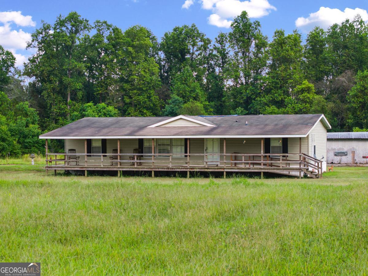 2014 Mobile Home on 3 Acres in Baxley, GA - Conveniently Located off Hwy 15 Welcome to your perfect country retreat! This well-maintained 2014 mobile home sits on 3 beautiful, private acres in the outskirts of Baxley, GA. Located just off Hwy 15, this property offers rural living while still being close to town amenities, making it an ideal spot for anyone looking for a peaceful, yet accessible location. This home offers approximately 1680 Sqft of heated space with a nice size open front porch.