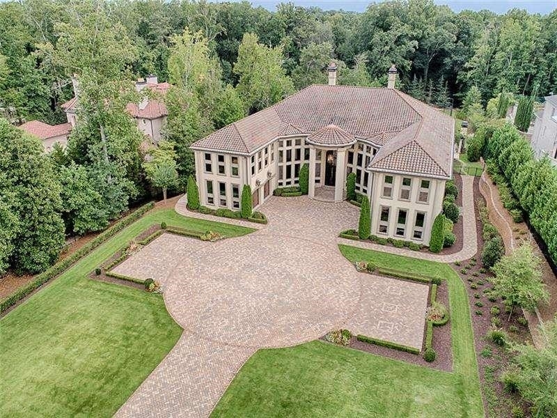 Situated on 2.2 manicured acres this European estate completed in 2011 is a one-of-a-kind masterpiece. Convenient to the city, yet close to the walking trails of Sope Creek and the Chattahoochee River National Recreation Area. It is within chipping distance to the Atlanta Country Club links, yet set back on a marque street lined with gas lamp lit estates. The elegant and inviting interior sets a stunning stage. You will marvel at the symmetry, the size, the many windows, 157 windows that provide breathtaking views of the lush grounds.Four outdoor verandas overlook the completely fenced, professionally landscaped and lighted, gated property with custom designed saltwater pool and tennis courts. 20' custom iron doors frame the 30" domed ceiling foyer. Just past the floating staircase you will find the grand room the fireplace developed as an incredible focal point. The main kitchen expanded to welcome guests and naturally transcended as the heart of this home. On the finished terrace level, you will find the climate-controlled wine cellar, tasting room, professional athlete designed gym, twenty-two seat theatre with is massive screen and 3D technology, game room and complete apartment. The outdoor living spaces feature a symphony of sounds bubbling fountain from the pool/spa area, the hum of the birds that call the expansive backyard home. It is there, just past the tennis court and the conversation fire pit area.... just pause and turn, just to look back at the home itself and realize the magnitude of your new home.