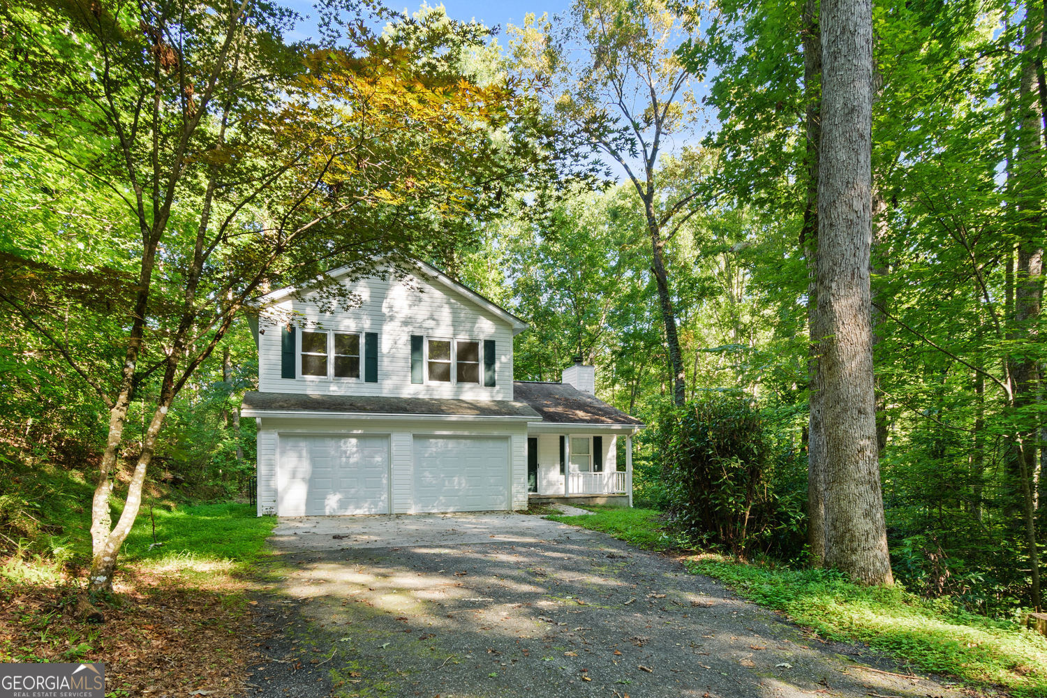 Charming traditional home on 2+ wooded acres in desirable Martins Grove-just 6 minutes from historic Dahlonega and UNG. No HOA and no rental restrictions! This open floor plan is perfect for family gatherings or entertaining, with a cozy fireplace in the great room that flows into the kitchen and dining area. Enjoy peace and privacy on the oversized deck overlooking rolling woods. Upstairs features 3 spacious bedrooms, including a primary suite with ensuite bath. A bonus main-level bedroom with private entrance offers flexible living-ideal for guests, multi-gen, or office. Freshly painted with new light fixtures and ceiling fan on main level. With close proximity to wineries, trails, and waterfalls, this home is ideal for families, students, or short-term rental income. Move-in ready-homes in this location rarely come available and won't last long! Insane Buyer Opportunity! I've teamed up with Capital Mortgage Solutions to offer a 1% down loan program where the lender covers the additional 2%-up to $7,000 for qualified buyers! That means you could get into this home with just 1% down and the lender provides the rest! Call Ben Thornton at Capital Mortgage Solutions to see if you qualify!