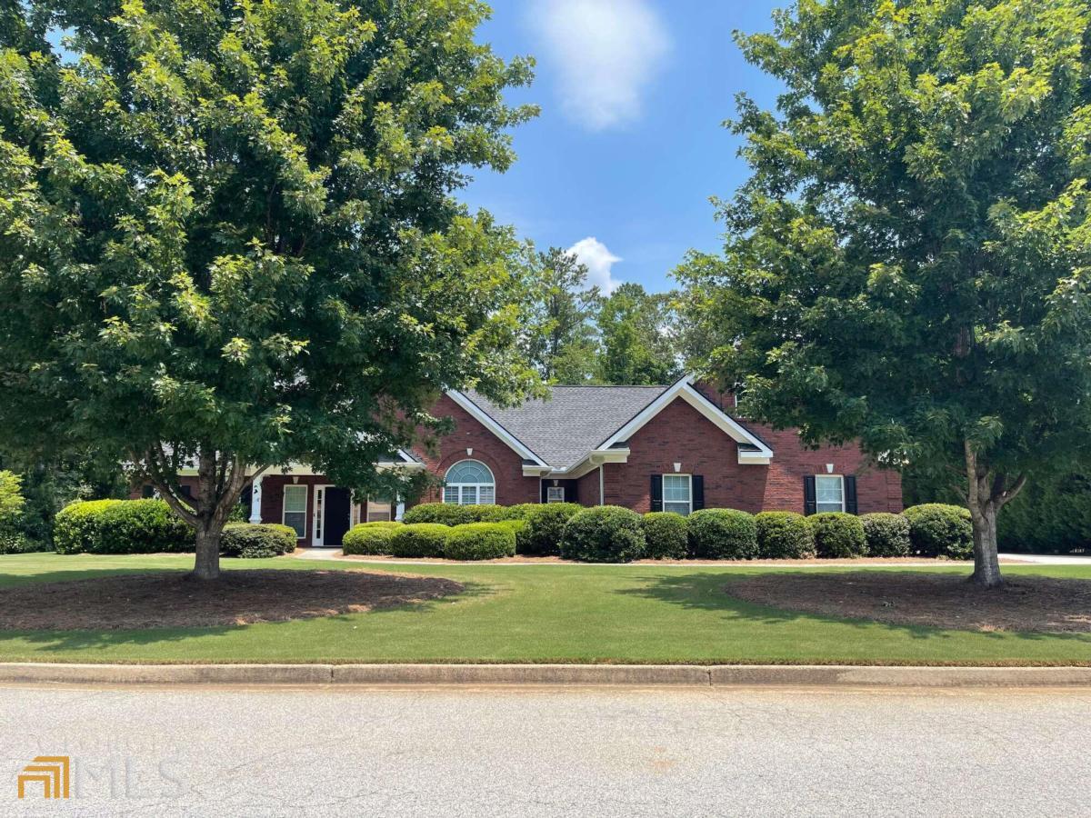 You must see this beautiful, 4 BR/2.5 BA, 4-sided brick home in convenient Conyers neighborhood. Minutes to shopping, dining, and I-20. Huge family/living room with open concept dining room. Wonderful kitchen with solid counter tops, stainless appliances, custom cabinetry, and breakfast bar. Large owner suite with huge ensuite that has garden tub, shower with seat, tile floor, two vanities, and his/hers closets. Ample sized secondary bedrooms and massive bonus room with closet and attic access. Awesome screened porch with fireplace and tile floor. Patio adjacent to screened porch with pergola. Backyard is fenced with beautiful fence. TWO, two-car garages! One garage has counter and sink for quick clean-ups. Lots of storage space! Also, a large,unfinished extra room upstairs adjacent to bonus room/bedroom.