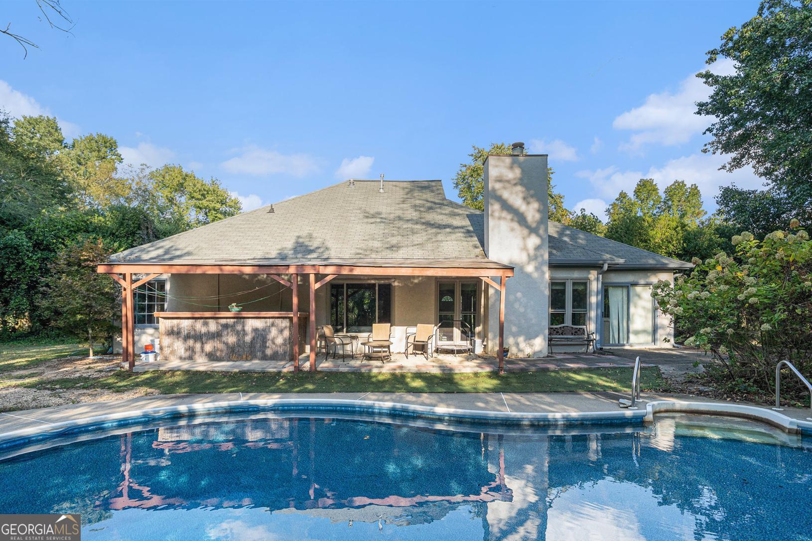 Your private paradise awaits! Dive into the heated, inground saltwater pool, unwind under the cabana, or entertain on the upgraded and extended patio-all within a fully fenced backyard that offers ultimate privacy. This charming 3-bedroom, 2-bath stucco ranch is tucked at the end of a quiet cul-de-sac in the sought-after Friendship Ridge subdivision. A 2-car garage plus an added one-car carport provide plenty of parking. Updates include all-new windows (2024), fresh exterior paint (2024), and recently replaced carpeting throughout the main living areas and bedrooms. The spacious master suite features his-and-hers closets, a jacuzzi tub, double vanity, and tile floors. No HOA and no rental restrictions. A serene, private retreat perfect for relaxing, entertaining, and making memories with family and friends!