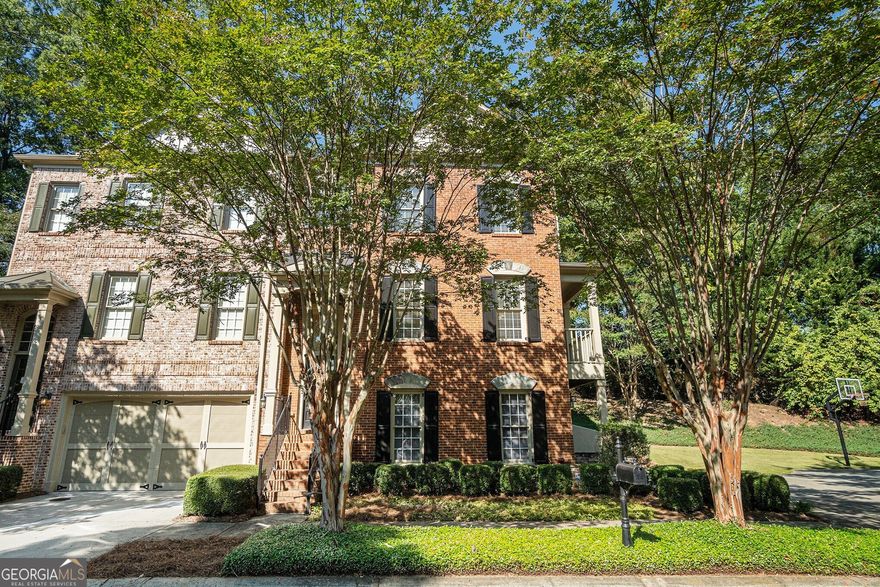 Gorgeous Brick End Unit Townhome in Coveted Cobblestone Walk, Marietta! Zoned for the Highly Sought-After Wheeler High School District and just Minutes to The Battery and Truist Park. Step inside to be greeted by Tall Ceilings, Hardwood Floors, Crown Molding, and an abundance of Natural Light. The spacious Living Room seamlessly flows into the Formal Dining Room a perfect setting for Hosting Guests and Creating Memories. Continue down the hall to the Fireside Family Room, complete with Oversized Windows and Direct Access to your Private Balcony. A charming Breakfast Nook wrapped in a Wall of Windows provides the perfect spot for casual meals. The open layout leads into the Chef's Kitchen, boasting a Breakfast Bar, Stained Cabinets, Stone Countertops, Stainless Steel Appliances, and a Generous Pantry. A convenient Powder Room completes the main level. Upstairs, retreat to the expansive Primary Suite featuring a Tray Ceiling, and space for a Sitting Area. The Spa-Like Ensuite Bathroom showcases a Double Vanity, Soaking Tub, Separate Shower, and a Large Walk-In Closet. An additional Ensuite Bedroom with a Full Bathroom, and Walk-In Closet is also found on this level, along with a conveniently located Laundry Room. The Daylight Terrace Level offers incredible flexibility with a spacious Bonus Room, ideal for a Home Office, Gym, Playroom, or Media Room. A Third Bedroom with Full Bathroom completes the lower level. Outside, enjoy both a Covered Patio and Rear Deck, perfect for entertaining or relaxing under a Peaceful Tree Canopy. A 2-Car Garage adds convenience and function to this already Captivating Home. All of this just Minutes from Historic Marietta Square, KSU, the Chattahoochee River Recreation Area, Multiple Nature Trails, Parks, and Easy I-75/85 Access. This is the Perfect Blend of Location, Lifestyle, and Luxury Living in the Heart of Marietta!