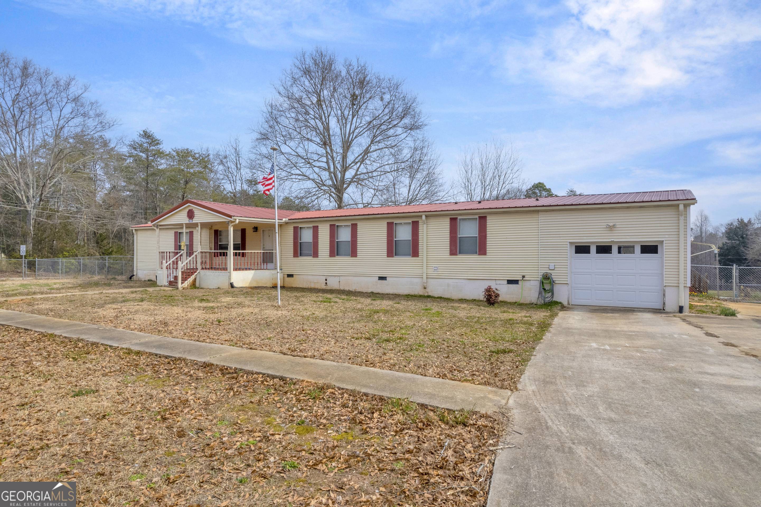 Very private home two blocks from beautiful Lake Hartwell. This 4 bedroom, 2 bath has a custom kitchen, family room w/ fireplace, separate laundry room, huge master bedroom & bath and a screened porch with attached deck. Outside you find almost 1.5 acres totally fenced with gate. Three garages and a huge workshop. Beautiful landscaping including, 3 fig trees, 1 peach tree, 3 pear trees, and 1 apple tree. Short walk to Lake Hartwell where you have boat ramp, fishing piers, and picnic area. This "escape property" is worth seeing!