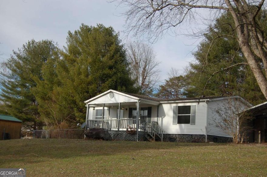 Permanently affixed Manufactured Home with 3 Bedrooms 2 Baths. Conveniently located close to Restaurants, Shopping and Lake Chatuge recreation areas. Included is a Large Fenced area off of the front and side area of the home. Storage shed, and Carport. The yard is a level terrain. Front and back covered porches. Priced to sell "As Is" condition.