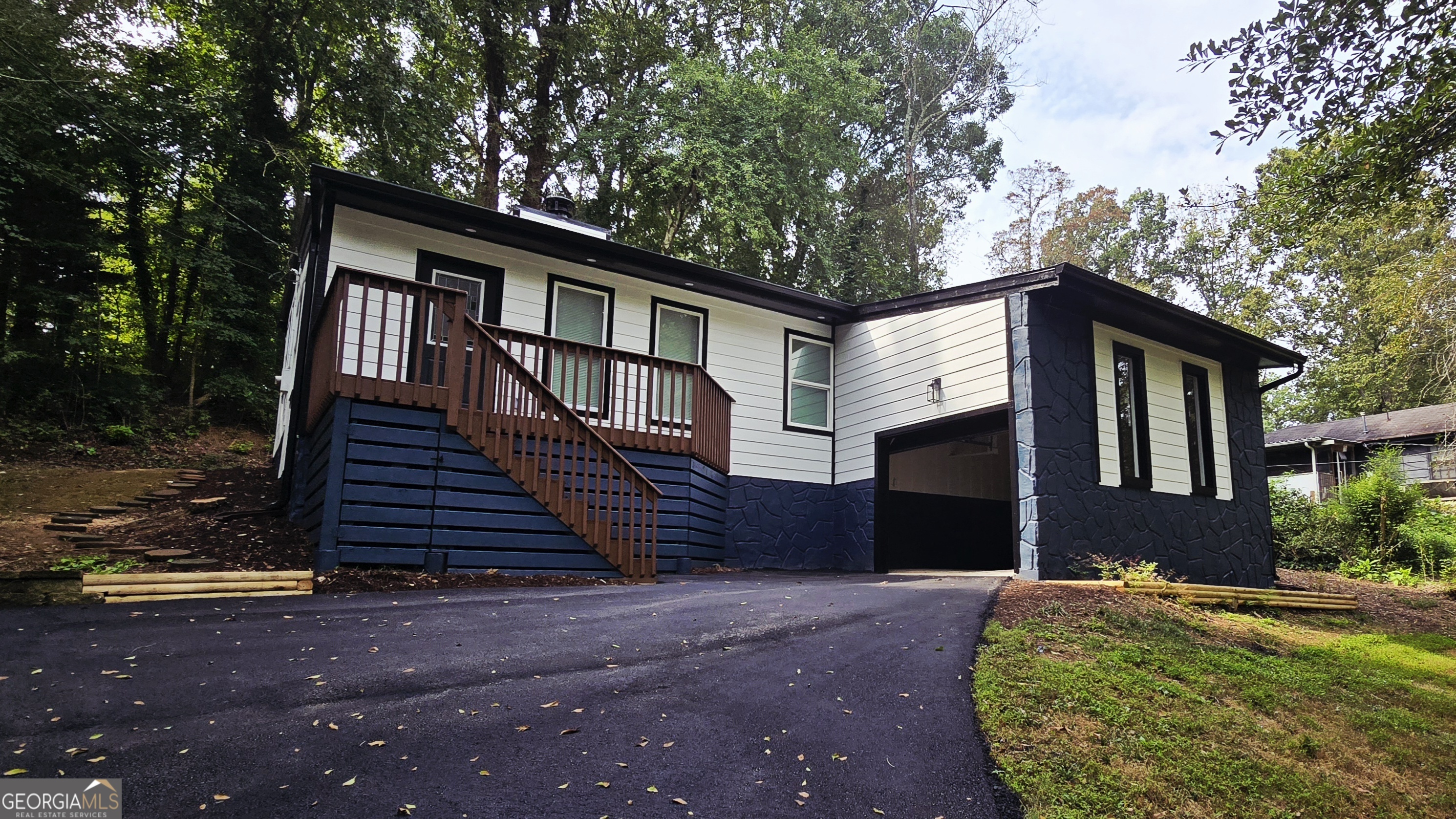 This updated split-level 3 bedroom, 2 bathroom home offers spacious living in a highly desirable location-just 6 minutes from public boat access on gorgeous Lake Lanier and 8 minutes from Gainesville's charming downtown square. Nestled near the Chattahoochee Country Club and Golf Course, this property features no HOA but enjoys a private setting in a quiet, welcoming neighborhood. Inside and out, nearly everything is NEW: fresh interior and exterior paint, new windows and doors, brand-new central heating and air system, fully renovated kitchen with new cabinets, granite countertops, and stainless steel appliances (fridge, microwave, and dishwasher). Bathrooms are completely updated with new vanities and glass shower doors. Plus, all lighting (interior and exterior), outlets, and switches are new, as well as updated plumbing, LVT flooring, rear deck, gutters, trim, baseboards, a new driveway, and crawl space insulation. Don't miss your chance to make this move-in-ready home yours today!