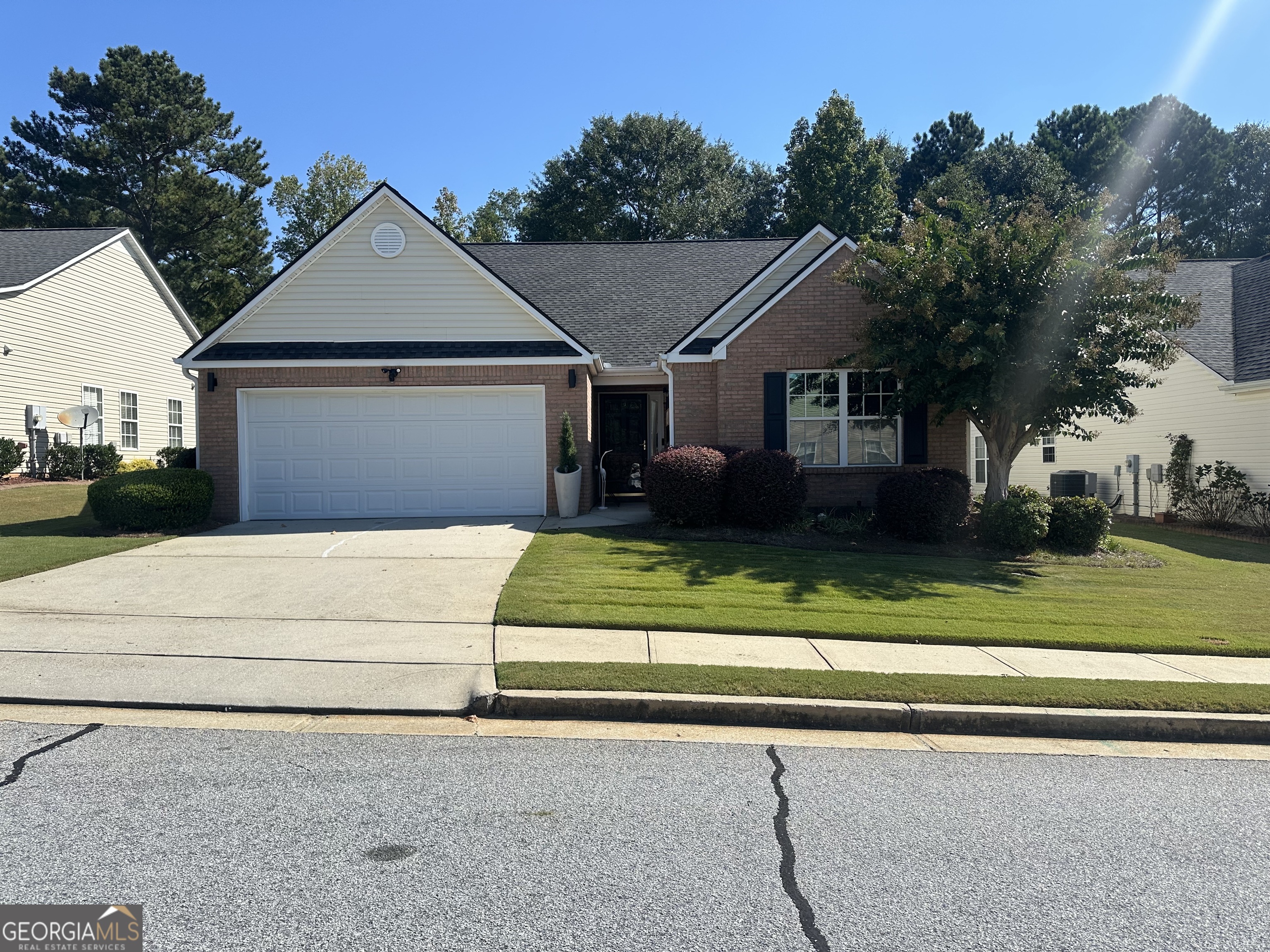 Welcome to this beautifully updated 3 bedroom, 2 bath brick front ranch located in a vibrant 55+ swim and pickleball community. Offering one of the largest floor plans in the neighborhood, this home has been thoughtfully renovated from top to bottom and is truly move-in ready. Step inside to find all new luxury vinyl plank flooring with no carpet anywhere. The vaulted great room features a cozy corner fireplace and opens to a bright sunroom/flex space, perfect for a home office or relaxation area. The renovated kitchen showcases stunning new quartzite countertops with waterfall edges and a walk-in pantry, while the adjacent laundry room provides easy access to the garage. The spacious owner's suite includes a tray ceiling, a renovated bath with modern finishes, large walk-in shower, and generous closet space. Two additional bedrooms and a fully updated hall bath are tucked away on the opposite side of the home for privacy. Designed for stepless living, this home combines comfort with convenience. Freshly painted throughout, every detail has been refreshed to create a light and welcoming feel. Enjoy a low-maintenance lifestyle with community amenities, while being just minutes from shopping, dining, and medical facilities.