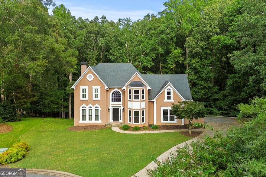 Beautiful home on a private, wooded, 3/4 acre cul-de-sac lot just a stone's throw from Lake Allatoona in sought after Eagle Watch. Must see! Renovated kitchen and baths. Hardwoods throughout. Finished basement with full bath and kitchen creates a fantastic in-law or teen space. Large windows provide ample light. Large separate dining room and great room are wonderful for entertaining. Don't miss this incredible home.