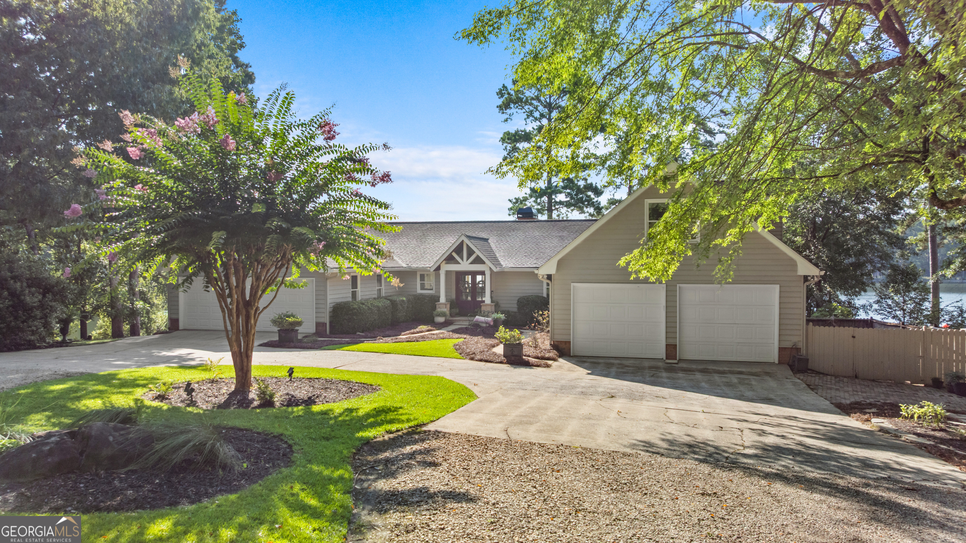 Spectacular Lakefront Home on the Richland Side of Lake Oconee . This stunning custom-built lakefront home offers over 200 feet of water frontage, panoramic 180 sunrise views, and deep water at over 12 feet off the dock, perfect for enjoying Lake Oconee's premier lifestyle. Situated directly across the cove from the exclusive Homesteads Estates of Reynolds Lake Oconee, this property boasts a granite seawall and vinyl max dock with two boat lifts, a jet ski lift, and quick access to the Ritz-Carlton by water. The main level showcases hardwood floors, a great room with a stone fireplace, a gourmet kitchen with gas line option, formal dining, a private office with exterior entrance, and an all-season sunroom overlooking the lake. The owner's suite features breathtaking lake views, deck access, an updated spa-like bath, walk-in closet, and custom built-ins. The terrace level is designed for entertaining and extended living with a second kitchen, great room, enclosed sunroom, additional bedroom, cedar closet, bunkroom, and lakefront storage. Above the second 2 car garage, you'll find a flex/bonus room ideal for guests or a hobby space. Outdoor living is at its finest with covered porches, a grilling deck, and a covered patio by the water. Additional highlights include an irrigation system with pump from the lake, deer fencing, water softener, security system, tankless water heater, two HVAC units, and proximity to world-class amenities. This is luxury lake living at its best-ideal as a full-time residence or a second home retreat.