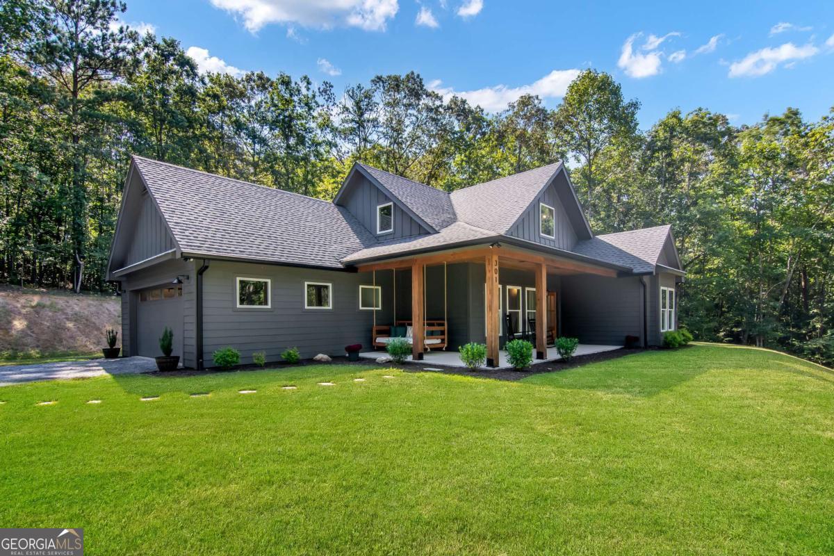 Welcome to this beautifully maintained 3-bedroom, 2.5-bath home situated on 5.44 private acres just minutes from town! Offering 2,196 sq ft of living space, this property combines a peaceful, secluded setting with the convenience of being only 8 minutes from town. The main level features a spacious open-concept living room and kitchen with an eat-in dining area and two pantries, perfect for storage. The primary suite is conveniently located on the main floor, along with a dedicated laundry room. Upstairs, you'll find two additional bedrooms and a full bath, providing plenty of space for family or guests. Outdoor living is a dream with a large covered wrap around front porch with a bed swing (included!) and a covered back porch. The oversized 2-car garage offers ample parking and storage. With 5.44 acres, there's plenty of room for homesteading, gardening, or creating your own mini farm. This property offers a rare blend of privacy, charm, and convenience - ready for its next owner to love! Listing agent is also the owner. Please call or text to schedule showings, as the home is being occupied while listed. Please no drive-by's as the home is located on a private road.