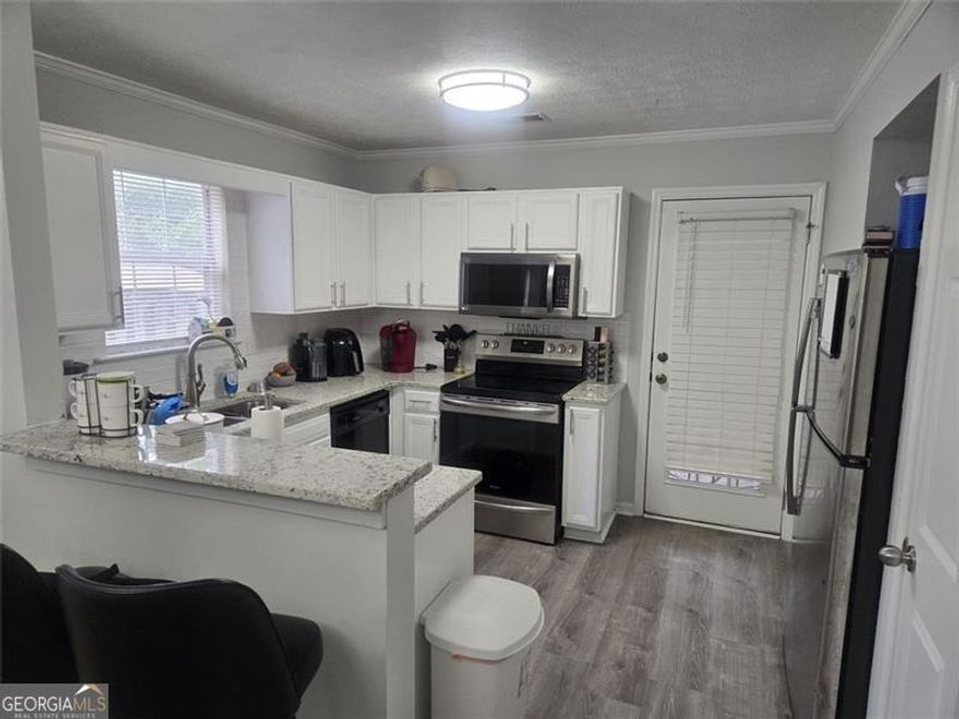 PRICE TO SELL QUICKLY!    Come see this Beautifully Updated 2 Story End-Unit Townhome with Spacious Lot   Welcome to 5980 Sherwood Trace, a well-maintained and updated 2BR/2BA end-unit townhome featuring a bright open floor plan, beautiful, laminate flooring, and a cozy fireplace in the family room. The updated kitchen includes granite countertops, modern stainless-steel appliances, and ample cabinet and counter space that opens to your dining area.  The primary suite offers a walk-in closet and private bath, with an additional bedroom and full bath on the main level. Enjoy outdoor living in the fenced backyard, open corner lot spacing, storage shed and a spacious deck, ideal for gatherings, pets, or play.  Located on a quiet street, this property offers excellent flexibility for homeowners or investors. Convenient to I-20, schools, shopping, dining, and parks.  Schedule your appointment today!