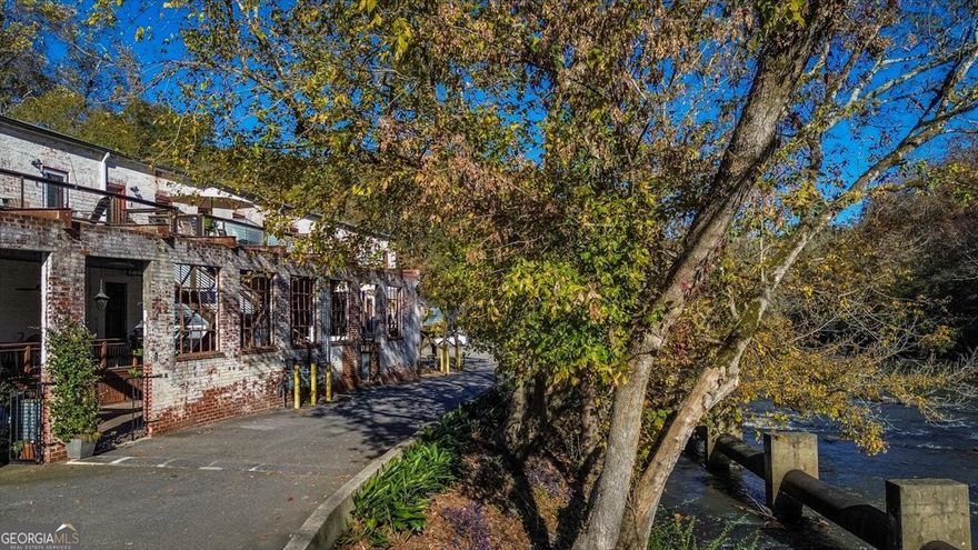 This one-of-a-kind condo offers a fabulous combination of indoor loft living and private outdoor space. Combine this with the unique charm of the Whitehall Mills Loft courtyard units, and this is a rare opportunity for the next owner!    The entry features a view overlooking the sights and sounds of the Oconee River. But thats just the beginning. Your entrance has a private deck space where youll want to linger for morning coffee or enjoy your evenings relaxing to the view and sounds of the rivers rushing water. This unit also offers dry storage space under that deck to tuck possessions away. Inside, you'll be wowed by the open concept floor plan, which makes this unit feel grand. A private nook (once an elevator shaft in the old mill) provides a flex space for an office, media area, or study, etc.  The updated kitchen offers marble countertops, an island, a double sink; gas cooktop stove and hood, and a huge walk-in pantry. In the kitchen, the upgrades include stainless steel appliances and new custom cabinetry. The open first floor also includes a laundry room w/included washer and dryer, and storage area.  Natural light beams down the staircase that leads upstairs to the oversized bedroom. With big windows overlooking the hillside, this room is filled with natural light, yet quiet and private. Here you will find a loft sitting area (now an exercise nook), walk-in closet with shelving, and ensuite bath. Whitehall Mill Lofts provide a unique, upscale living community along the Oconee River where  history and contemporary living spaces beautifully meet. Whitehall Mill Lofts is known for its sense of community, lovely neighbors and is dog friendly. The HOA fees take care of virtually everything: water, trash, sewer, road maintenance and a termite bond are included as well as fire insurance, exterior maintenance of the roof, walls, and care for the???????????????????????????????????????? property.