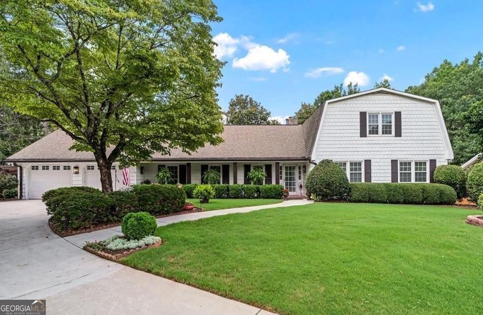 Classic Chathambilt charm meets modern comfort! This rambling ranch is distinctive, gorgeous and whimsical. Effortless one-level living with additional bedrooms and full bath upstairs-blends classic design with modern living. The expanded chef's kitchen completed in 2021 features an impressive dual-fuel Z-line gas range, quartz counters and custom cabinetry. Cozy up in the family room anchored by a stone fireplace. Entertain in the separate dining room or use it for an office or play space. You will love the primary retreat with fireside sitting area, vaulted ceilings, luxury bath, and custom closet. All bathrooms have been fully modernized. Heated-and-cooled vaulted sunroom will be your favorite, sun-filled room! Outdoor living shines on a gorgeous level lot with a fenced backyard, inviting deck and patio, and beautifully landscaped yard. You must experience it in person! 2 car garage leads to hard working laundry PLUS a mud room. Don't miss the large outbuilding with electric and green house, Ideally located near Crabapple, Historic Roswell, and top North Fulton amenities, this non-HOA community is admired for its iconic streetscapes and welcoming neighborhood feel. Experience the best of Roswell and North Fulton living!