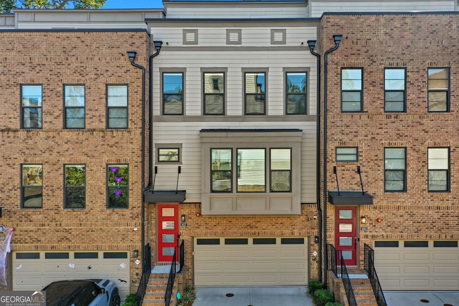 Welcome to the Future! Your new Smart Home is waiting for you at Altus at the Quarters (Phase I). This wonderful townhome, with its new solar panel array and back-up battery, is one of only 54 units in the community that offers you the most cutting edge technology in Smart Home Living. Power outages will no longer leave you in the dark, as your Smart Hub operates a Home Automation Network that will keep your home running "as usual", while your neighbors search for flashlights. This home comes equipped with an electric vehicle charger, smart-locks, smart thermostats, security cameras, WIFI appliances, electric roller shades, and a home security system. The Hutton floor plan is the largest floor plan in the community! Freshly painted throughout, you will be delighted by the many upgrades that the owners have added throughout the home. The first level of this home makes a perfect office space and features hardwood floors as well as a separate storage room. The kitchen is the sparkling centerpiece of the 2nd level with its glass-panel pantry door, upgraded cabinetry, stainless steel Smart Appliances, gas cooktop with stainless hood, wall ovens, quartz counter tops and timeless hardwoods. This level also offers large family and dining spaces, an office nook to pay bills, and a large private back deck with Magnolia tree views. The 3rd level features a large master bedroom with walk-in closet and master bath with soaking tub, as well as two additional bedrooms, full bath, and laundry closet. Make your way up to the 4th level, and you will see where you will likely spend much of your time! However you choose to use this room, you will love the 85" Smart TV that covers most of one wall and is flanked by two roof top decks. The owners have recently finished both decks with new exterior wood flooring creating a welcoming indoor/outdoor living space with gorgeous views of the city! West Midtown is booming, and you will be living in the center of the fun with a variety of new restaurants, breweries and entertainment including greens spaces, Beltline access, Top Golf, Westside Provisions and much much more!