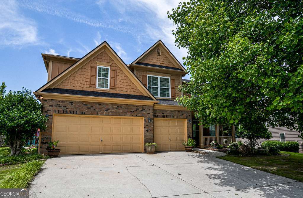 Welcome to this spectacular property! Discover this stunning 5-bedroom, 4-bath home with 3-car parking, nestled on a quiet cul-de-sac in Auburn, GA. Boasting over 4,200 square feet of thoughtfully designed living space across two levels, this home blends elegance, comfort, and functionality. Step into a bright two-story foyer that leads to formal living and dining rooms, perfect for entertaining. The spacious kitchen features stainless steel appliances, hardwood floors, a center island, and a breakfast area that opens into a cozy family room complete with a fireplace and built-in shelving. The main level includes a full bedroom and bathroom-ideal for guests or multi-generational living. Upstairs, a versatile loft area offers endless possibilities as a playroom, media room, or home office. The owner's suite is a true retreat with double vanities, a garden tub, separate shower, and a walk-in closet. Enjoy outdoor living on the large custom deck, perfect for relaxing or entertaining. Located in a highly desirable Auburn neighborhood, this is one of the largest homes available in the area-don't miss your chance to schedule a private showing today!