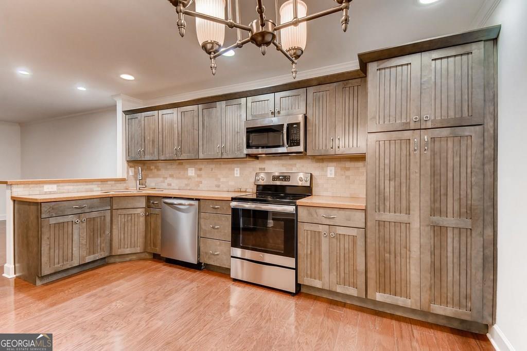 Perfect location in East Cobb & super close to The Battery. This updated 2 BR 2 Bath condo is move in ready for you to simply enjoy life. With a beautiful kitchen with all stainless steel appliances featuring granite countertops, great cabinets and large eating area as you enjoy views of the great room and fireplace. All the windows have wooden shutters along with hardwood flooring throughout. The one bedroom has large walking closets with lots of storage space. When the upgrades were done all the ceiling are flat without texture and recessed lighting enhances your experience. The HVAC was replaced just this October, the HOA replaced all plumbing lines in 2024 and makes it a worry free home. This unit is stepless which is a plus for many. The community is active and just 5 mins to Braves games, concerts and the great activities at the Battery. This is a must see unit and we welcome your showings!