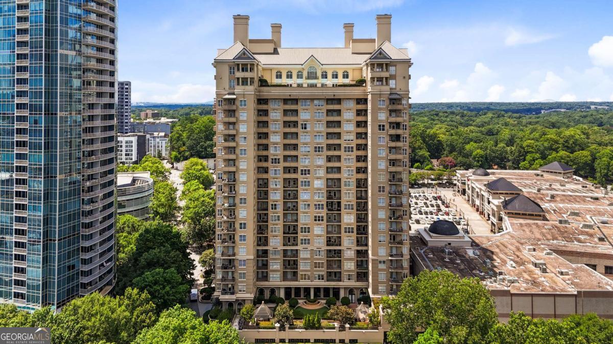 Perched on the 16th floor of the Meridian Buckhead, this light-filled corner unit offers sweeping sunset views and one of the most desirable layouts in the building. With three true bedrooms and windows on two sides, the open-concept living and dining spaces feel airy and inviting. The kitchen is equipped with custom ceiling-height cabinetry, granite countertops, stainless steel appliances, and a full-size pantry. Thoughtful upgrades include wide-plank flooring, designer lighting, modern fans, and sleek neutral tones throughout. The bathrooms feature frameless glass showers-one wrapped in floor-to-ceiling Carrera marble-double vanities, and contemporary fixtures. Each bedroom includes a custom closet system, and a spacious laundry room adds extra storage and convenience. Two assigned parking spots are included. Residents enjoy top-tier amenities: 24/7 concierge, rooftop pool, full fitness center with squash court and saunas, theater room, library with conference space, billiards lounge, and beautifully landscaped gardens with a putting green, fire pit, and grilling areas. All just steps from Buckhead's best dining, shopping, and access to Path 400.