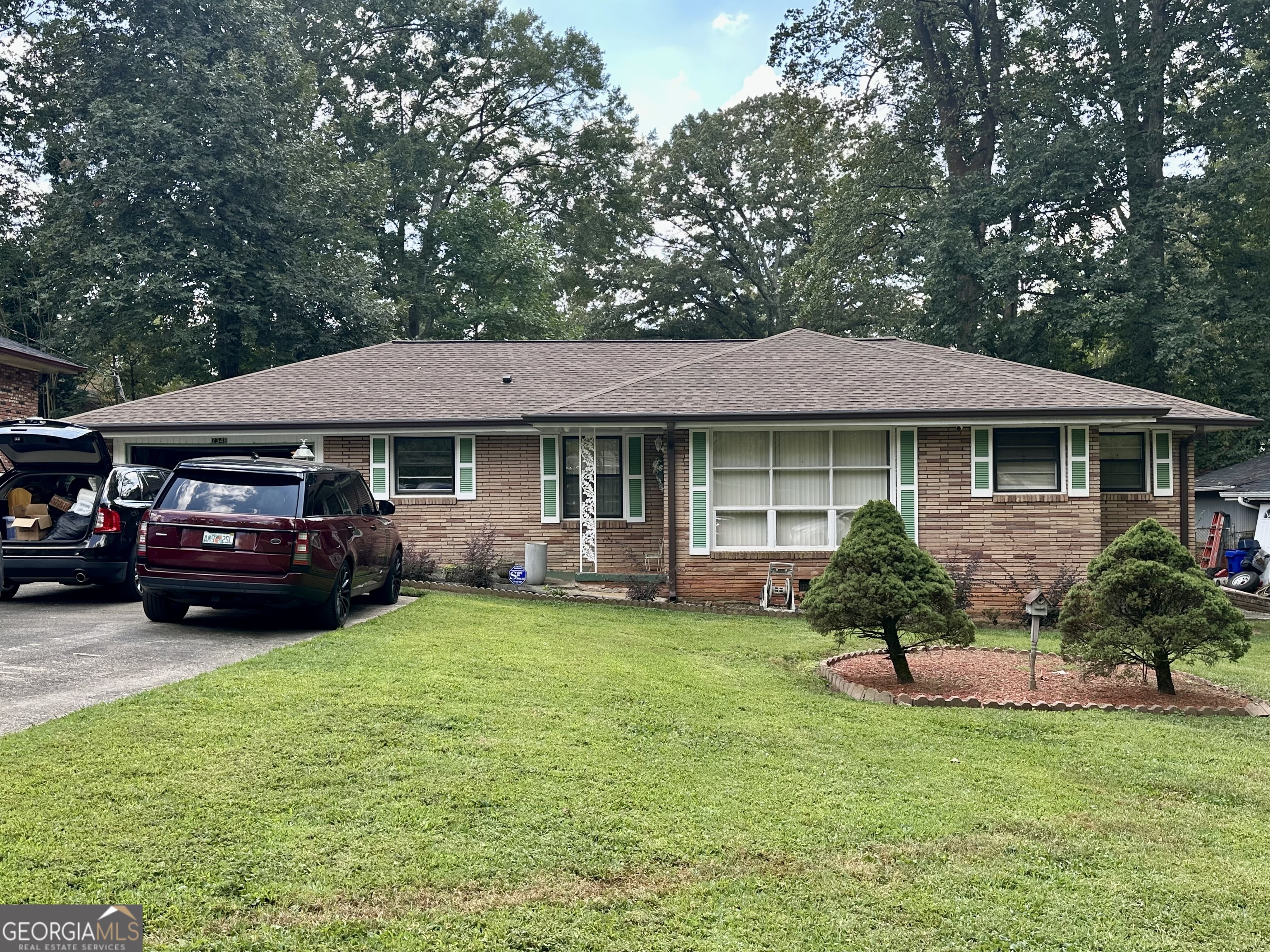 Discover this attractive 3-bedroom, 2-bath ranch in the quiet Candler-McAfee community. With over 1,800 sq ft all on one level, you'll enjoy a bright family room with a classic fireplace and a spacious, level yard ideal for relaxing or entertaining. The backyard is a true highlight, featuring a large work shed, a well-manicured lawn, and a huge patio running the full length of the house with a built-in planter shelf-perfect for gatherings, gardening, or outdoor living. A fenced-in backyard adds both privacy and security. The home's single-floor design means easy living and easy accessibility for everyone. Set among mature trees on a generous lot, this home offers a peaceful neighborhood feel with convenient access to I-285, downtown Decatur, and Atlanta. Parks, schools, dining, and shopping are all nearby. Whether you're downsizing, buying your first home, or looking for a smart investment, this property is priced to sell. Make Green Forrest Dr. your new address!