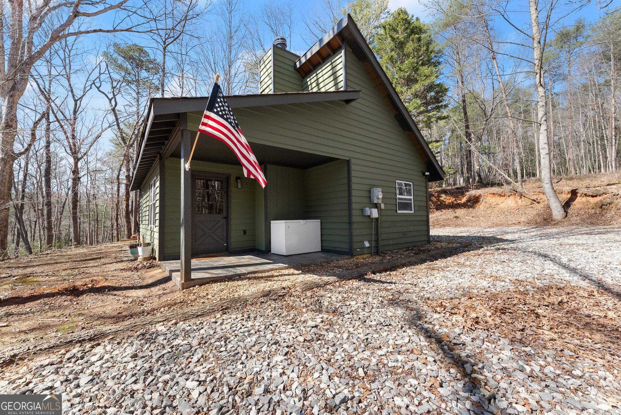 Welcome to Your Idyllic Mountain Retreat in Cleveland, GA. Nestled in the trees, this charming 2-bedroom, 1-bathroom cabin offers a serene escape on 3.79 acres. Enjoy ultimate privacy with only deer and turkey as your neighbors. Enter from the covered front porch into a warm and inviting living area. Discover a beautiful rock fireplace, vaulted ceilings, slate floors, 2 bedrooms, and a fully updated bathroom. The living room flows right into the kitchen which is equipped with granite countertops and brand-new stainless-steel appliances. There is a combo pantry and laundry off the kitchen as well. Up the stairs is a versatile loft area that is perfect for extra sleeping space, an office, or ample storage space. There have been loads of upgrades to this property including a new Tankless Hot Water Heater, New Washer & Dryer, All New Kitchen Appliances, House Water Filtration System, Upgraded Well Pump, Septic System fixed with Access Point, Ceiling Insulation, Fresh Paint (inside and out), RV Hookups, New Carpet and Carpet Pad Upstairs, New Fans/Lighting (Inside and Outside), Updated Electrical Panel, and New Piping Throughout! All of this sits on almost 4 acres of private, wooded and usable land. The land is loaded with hardwoods, Wild Blueberries, Blackberries, and Flowers. Don't miss this fantastic opportunity to own a piece of North Georgia. Embrace the tranquility and natural beauty of this unique mountain retreat!