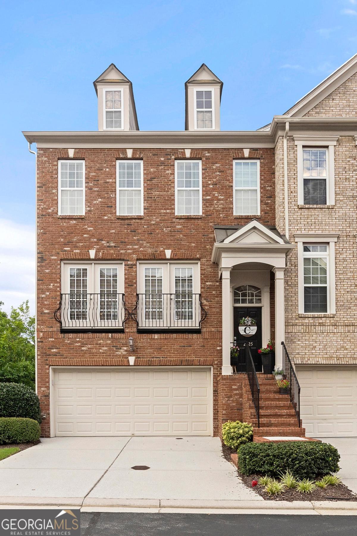 This stunning 3-bedroom, 3.5-bath townhome offers over 2,200 square feet of thoughtfully designed living space in sought-after Smyrna. You cannot beat this location and accessibility! Enjoy an open-concept main level with hardwood floors, recessed lighting, a half bathroom and a beautifully appointed kitchen featuring granite countertops, stainless steel appliances, a large gas range, and a breakfast bar that overlooks the dining and living areas - perfect for entertaining and quiet mornings in front of your gas log fireplace. The oversized primary suite on the second level features a spacious walk-in closet and a luxurious en-suite bath with double vanities, a soaking tub, and a separate shower. A secondary bedroom suite with its own private bath and walk-in closet is ideal for guests, a nursery, or a home office. The terrace level offers a third private bedroom and full bath that is ideal for a roommate, teen suite, or dedicated work/flex space - not to mention walk-out access to a private patio! Enjoy two outdoor living spaces overlooking the community green space. Additional highlights include a 2-car garage with ample storage and low-maintenance living with HOA dues that cover water, sewer, trash, lawn care, pool, dog park, and termite bond. Unbeatable location just minutes from Midtown, Downtown Atlanta, Truist Park, the Chattahoochee River Trail, and Hartsfield-Jackson Airport. Less than 5 miles to historic Downtown Smyrna and under 2 miles to local grocery stores and shopping. Don't miss this incredible opportunity. Let's schedule your private tour today!