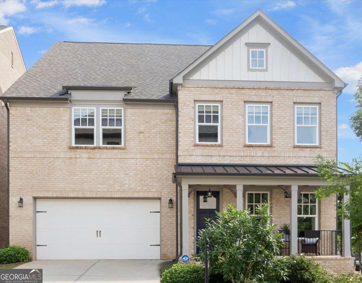 Nestled in the prestigious, gated Serenade community, this 3 sided brick home with charming front porch, seamlessly blends timeless design with contemporary comforts. Step inside to a welcoming foyer and dining area, an open-concept main level, featuring a gourmet kitchen with white shaker cabinetry and quartz countertops and stainless steel appliances. A large island, eat in kitchen area, walk-in pantry, butler's pantry and two-story great room with gas fireplace complete this perfect family and entertaining space. Engineered hardwood flooring flows throughout the light-filled main living area, with 10 foot ceilings and 8 foot doors enhancing the sense of space and sophistication. The main level also boasts a luxurious guest suite, (which could also be a main level master suite) that has a private ensuite bath with frameless tiled shower with seat, quartz counters and a generous walk-in closet. Upstairs, the primary suite awaits, a true sanctuary with "his and hers" walk-in closets featuring custom shaker-style systems . The spa-like primary bath includes a double vanity with quartz counters, soaking tub, designer tile and frameless glass shower. Two additional generously sized bedrooms have large walk-in closets, adjoined by a well-appointed Jack-and-Jill bathroom with each room having their own private sink areas. Upstairs laundry room and loft round out the ideal space. Enjoy outdoor living with a newly expanded solid surface patio and wrought iron fence, while mature landscaping adds to the serene ambiance. Convenient access to community amenities which include a pool with cabana and an outdoor fireplace. Beyond the impeccable confines, enjoy unparalleled access to Alpharetta's most sought-after attractions. Minutes away you will find Encore Park, Avalon, Downtown Alpharetta, Ameris Amphitheater and top-rated schools. Outdoor enthusiasts will appreciate Wills Park, the Alpha Loop, and Big Creek Greenway and the easy access to 400.