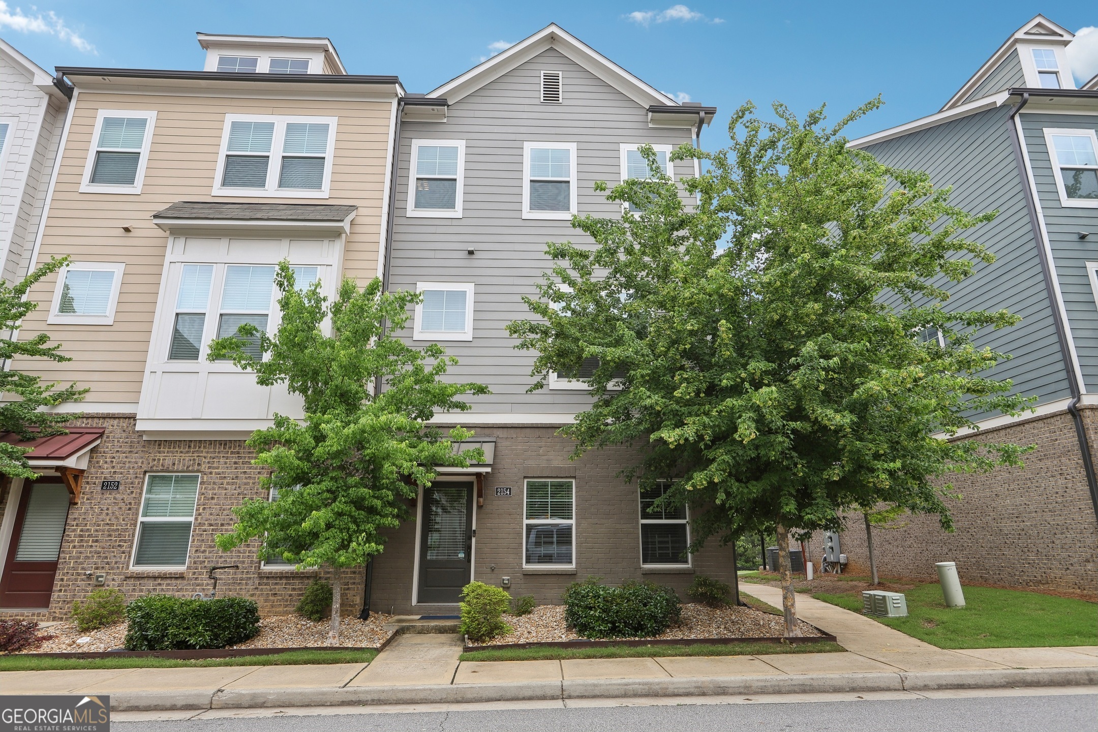Immaculate end-unit townhome offering the perfect blend of style, space, and location, just minutes from Downtown Atlanta, Smyrna, and the Cobb Galleria. Designed for modern living, the bright open floor plan is filled with natural light and enhanced by hardwood floors throughout and recessed lighting. The spacious family room features a gas fireplace and flows seamlessly into a gourmet kitchen with granite countertops, stainless steel appliances, convection cooking, and a large center island perfect for entertaining. Upstairs, the expansive primary suite offers a generous walk-in closet and a spa-inspired bath with a massive double shower. The laundry is conveniently located on the upper level, close to all bedrooms for easy access. As an end unit, this home provides added privacy along with a private back deck ideal for relaxing or dining outdoors. Enjoy a full suite of community amenities including a pool, tennis courts, clubhouse with gym, playground, and a walking path with direct access to Whittier Mill Park. A rare opportunity to own in one of Atlanta's most connected and sought-after locations.