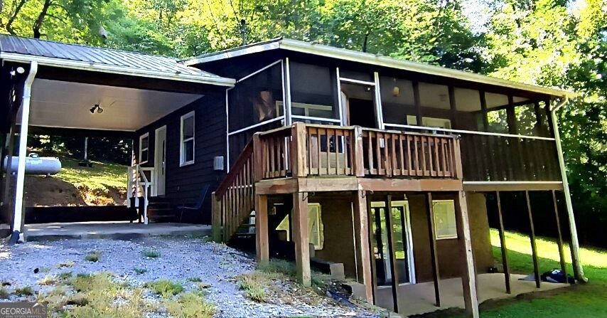 Level lot with level yard. Main level has larger living/dining room with fireplace. Main level has two bedrooms and one bath. Screen porch across the front of the house. One car carport. Basement level is finished with a bedroom, bath and living area with a private entrance. Small branch in the front yard. End of the road privacy.