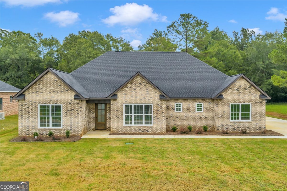 Welcome to your dream home in the sought-after Southern Hills Golf Course Community! This all-brick beauty offers 5 bedrooms, 3 bathrooms, and 2,550 sq ft of thoughtfully designed living space, perfectly situated on nearly half an acre. With views of the golf course in the front and wooded privacy in the back, you'll enjoy the best of both worlds. Step inside to find spacious, light-filled rooms and elegant finishes throughout. The heart of the home is the chef's kitchen, complete with a massive 12-ft granite island, pot filler, stainless steel appliances, and a butler's pantry for extra storage and prep space. The living room boasts an electric brick fireplace and a custom coffered ceiling, creating a warm and inviting atmosphere. Retreat to your backyard oasis where a spacious patio offers the perfect place to entertain or unwind while enjoying the peaceful wooded backdrop. Additional highlights: 5 generously sized bedrooms 3 full bathrooms No caprpet anywhere in the home! Nearly half an acre lot Prime location in a golf course community This home blends luxury, comfort, and convenience-don't miss your chance to make it yours!