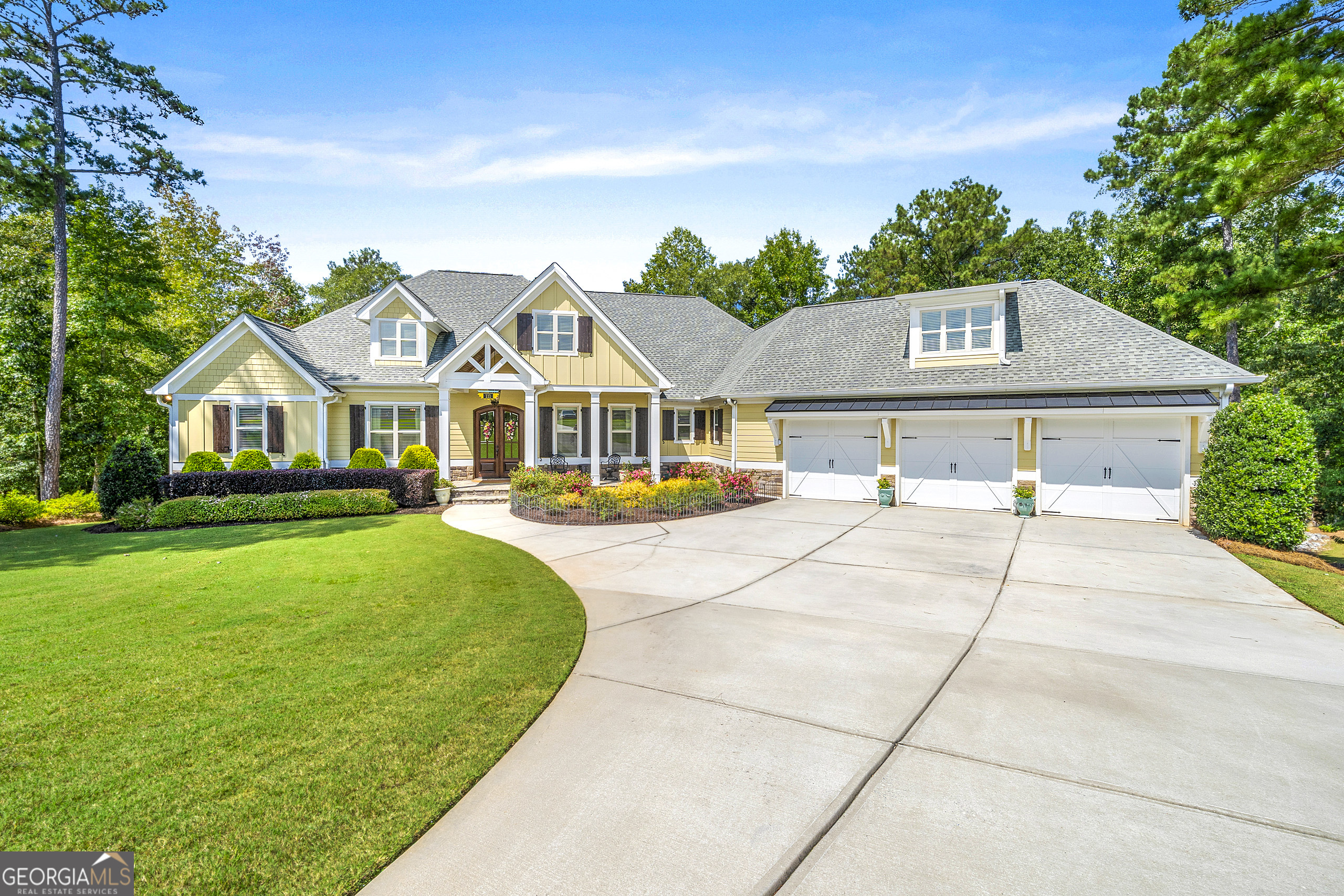 Tucked away at the end of a quiet cul-de-sac, this beautifully maintained ranch with a finished basement offers 1.22 acres and 200 feet of serene lakefront living. With approximately 6,556 square feet, including both finished and unfinished space, this home combines timeless craftsmanship with modern comfort. A flagstone front porch welcomes you inside through elegant wood and glass double doors into a light-filled foyer. To one side, a formal dining room features a coffered ceiling and wainscoting. On the other side, a versatile flex room provides space for an office, sitting room, or reading nook. The vaulted family room, complete with fireplace and built-ins, flows into the kitchen, which is designed with custom cabinetry, stainless steel appliances, a double oven, gas cooktop, pull-out spice racks, walk-in pantry, and an island. The adjoining keeping room, breakfast nook, and sunroom with a stained-wood vaulted ceiling and motorized custom shades all offer sweeping views of the lake. The primary suite is a retreat of its own, with a tray ceiling, sitting area with lake view, and a bathroom featuring an expansive dual sink vanity, a whirlpool tub, a walk-in shower filled with natural light, and a generous walk-in closet. Two additional bedrooms with a Jack-and-Jill bath, a powder room, and a well-equipped laundry room complete the main floor. The finished basement extends the living space with multiple open areas for entertaining, a kitchenette, office, dining area, large full bath, and ample storage. It also includes a storm-safe sitting room and a large unfinished space with shelving for seasonal decor. An oversized three-car garage and a whole-house water filtration system add convenience, while the community amenities include two lakes, a dock, pool, tennis courts, clubhouse, and 24-hour fitness center. Bring your kayaks, canoes, or fishing gear and enjoy life on the water. Just minutes from Trilith Studios, Trilith's boutique shops and restaurants, Piedmont Wellness Center, and with easy access to Fayetteville, Peachtree City, Piedmont Hospital, and the Atlanta airport, this home offers both tranquility and convenience. Be sure to view the 3D virtual tour link to fully appreciate everything this property has to offer.
