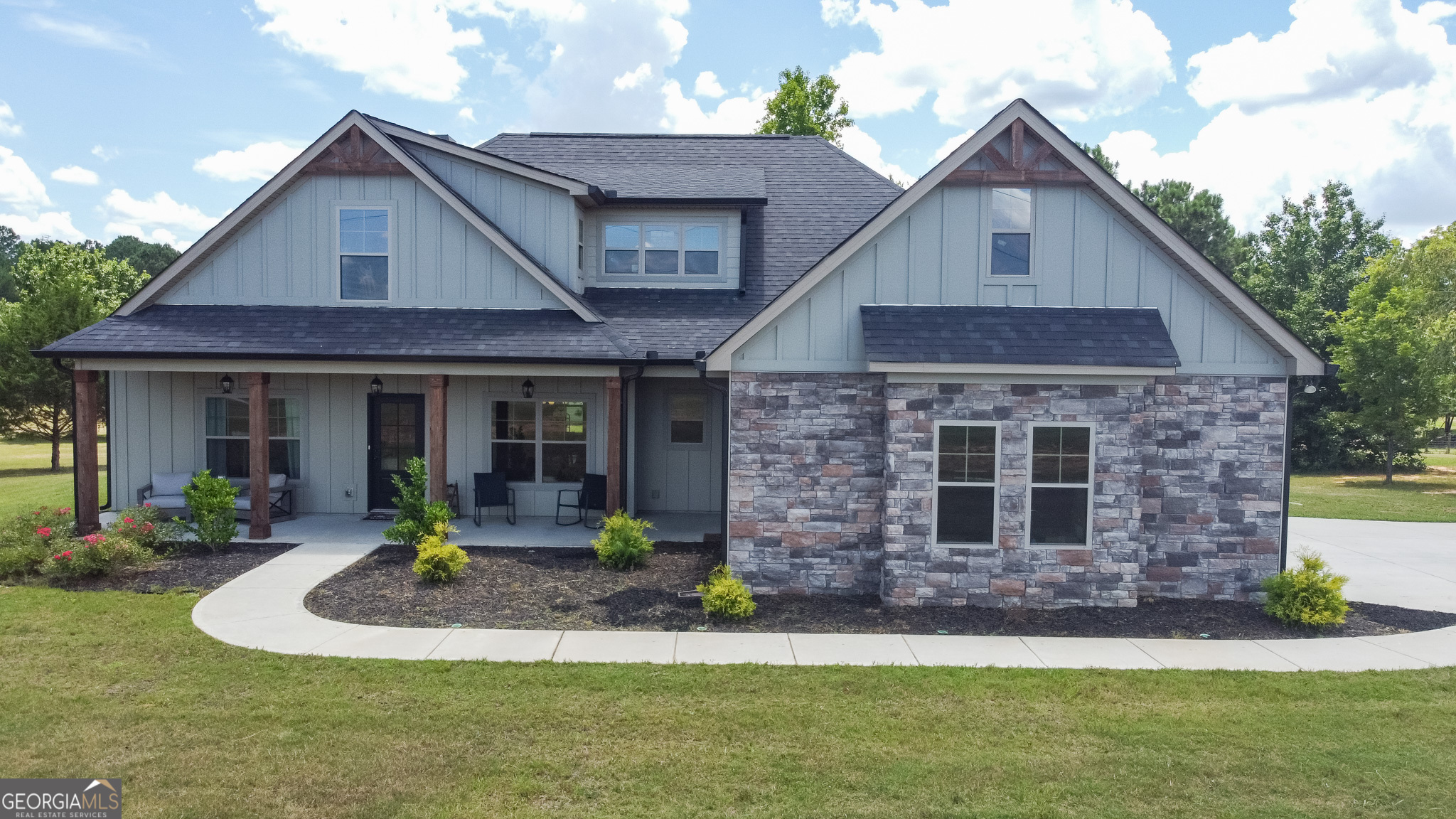This stunning 4BR/3BA home on 2.22 acres in sought-after Pike County- Built in 2022, is a modern home featuring an open concept floorplan and the owner's suite plus 2 additional bedrooms on the main level. This home boasts a vaulted family room with stacked stone fireplace, a large island perfect for family meals or hosting and features LVP throughout the living area and in secondary bathrooms. Upstairs includes a private guest suite or bonus room with full bath and loft space. Enjoy peaceful views from the covered back porch with cozy outdoor fireplace. Ideal for those seeking a slower pace of life, yet conveniently located near Senoia, Griffin, Williamson, and Newnan. A perfect blend of comfort, space, and convenience!